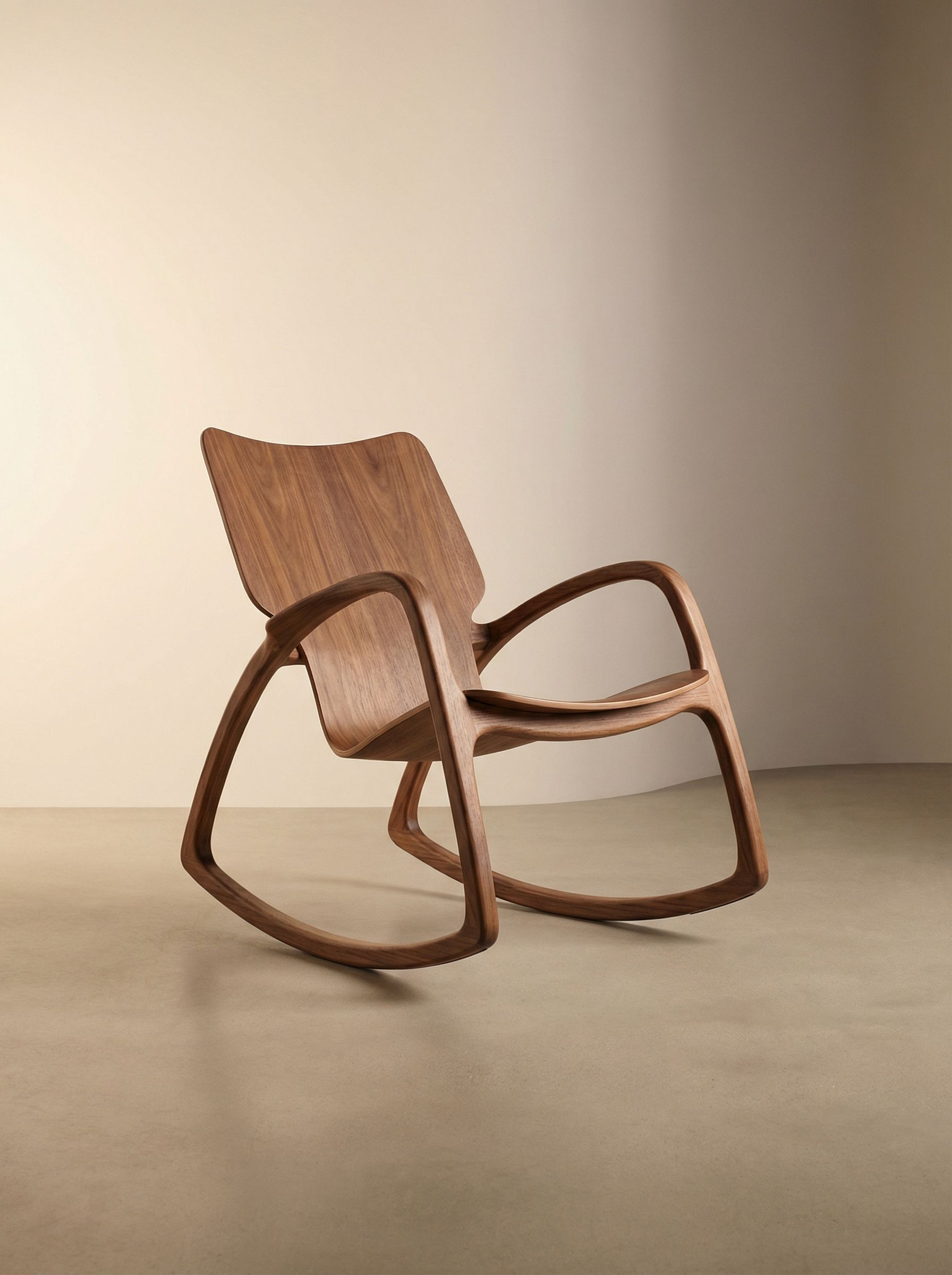 Modern wooden rocking chair on neutral backdrop