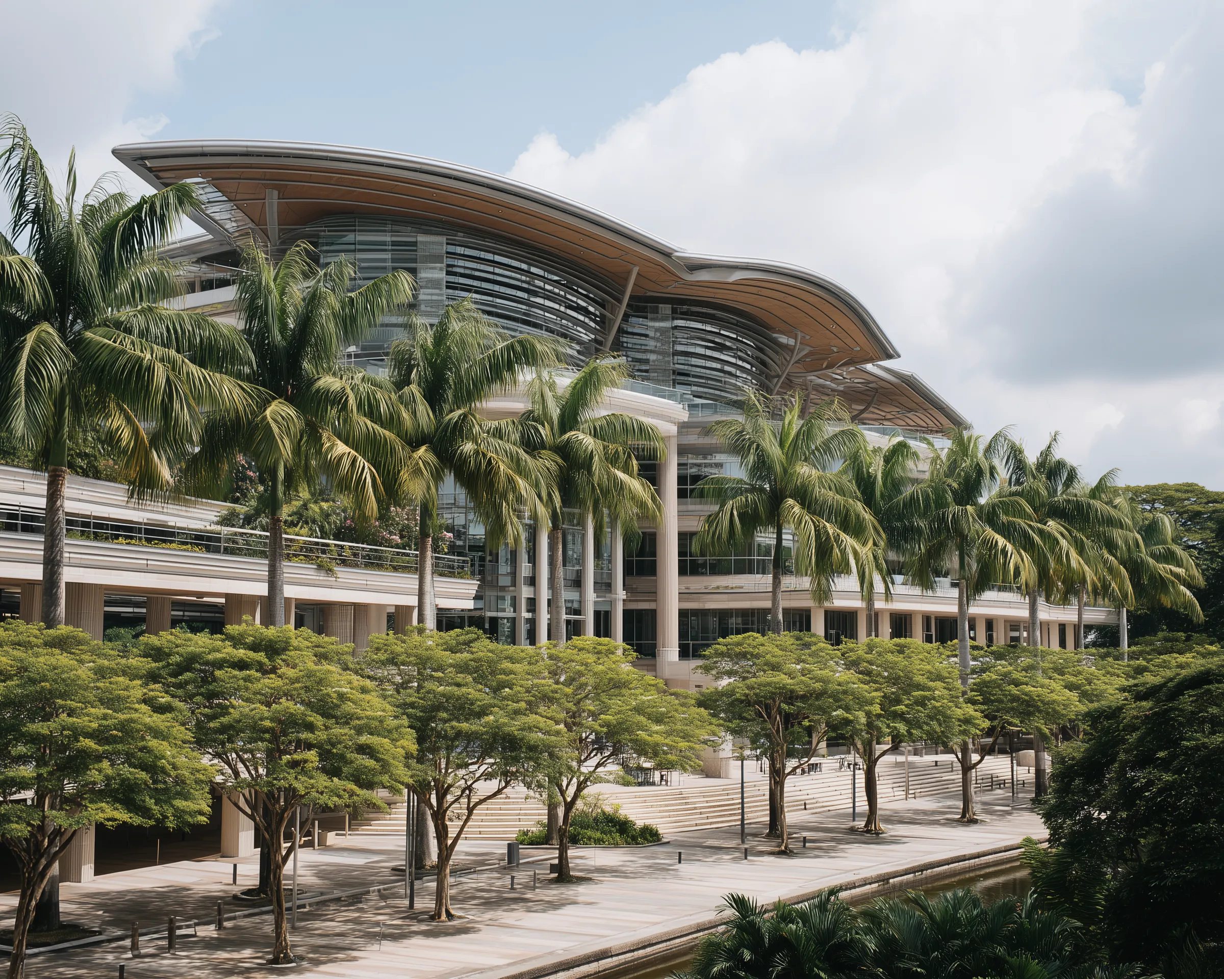 Modern tropical glass building with palm trees