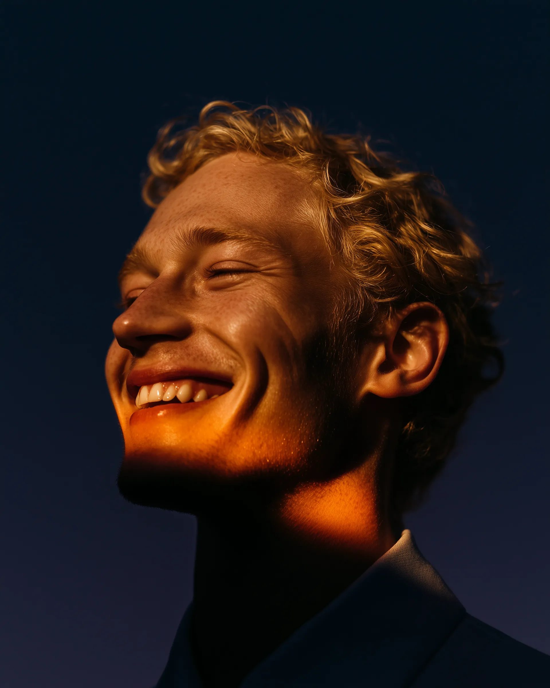 Dramatic golden-hour portrait of smiling man