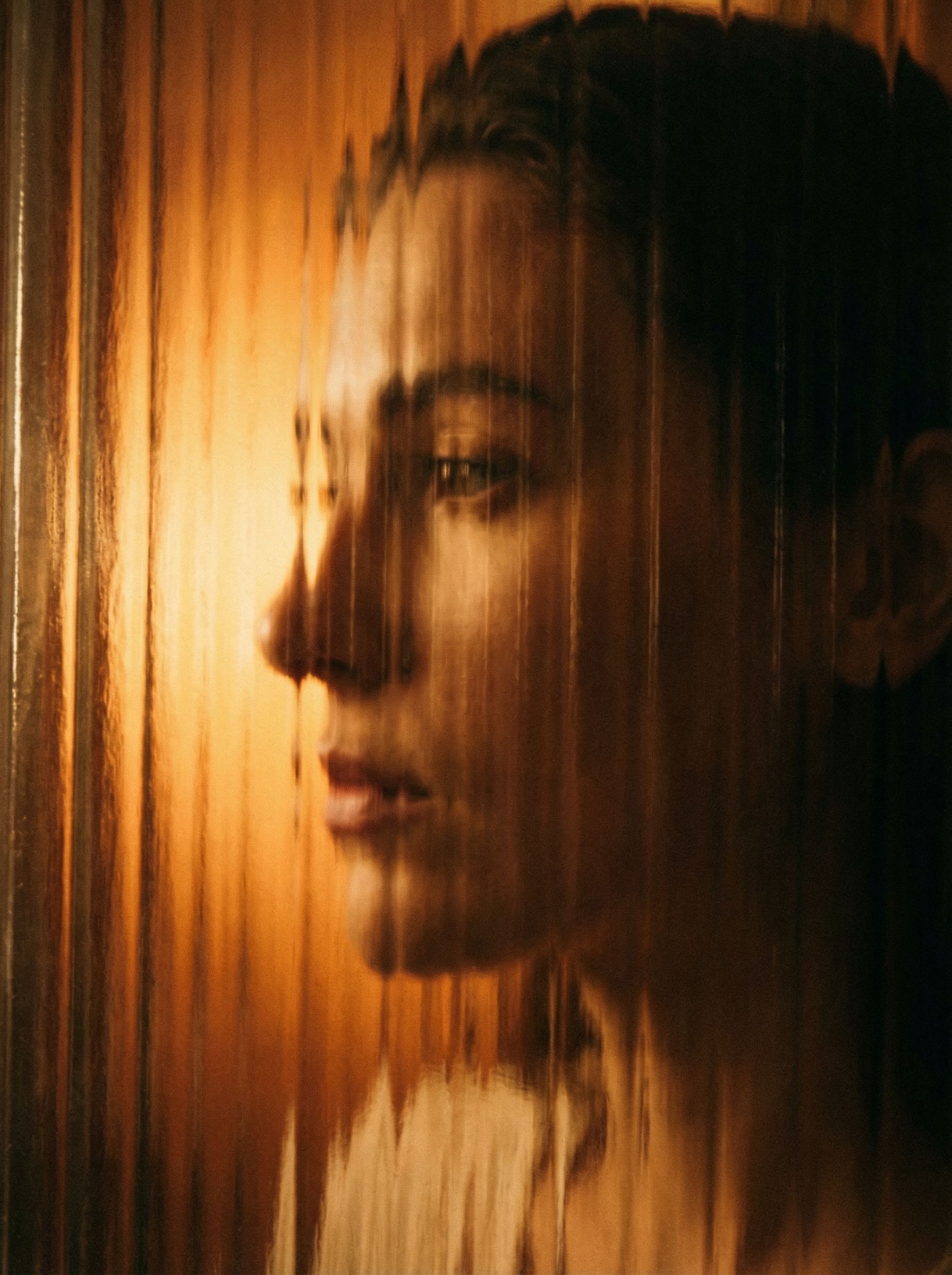 Abstract portrait behind textured glass