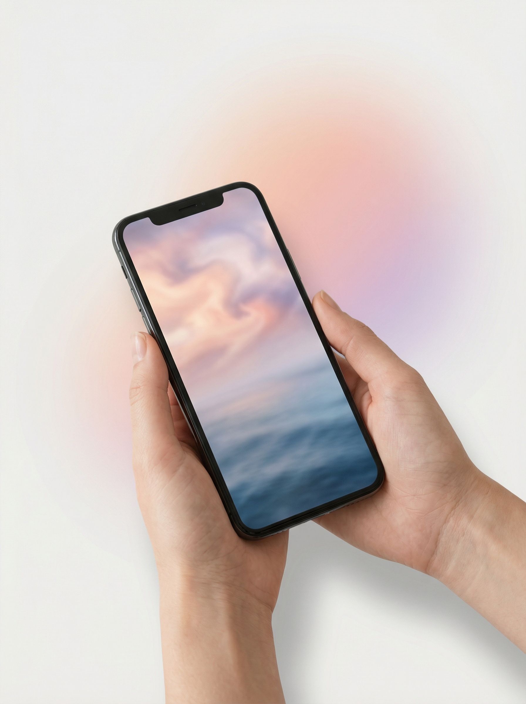 Hands holding smartphone with pastel screen