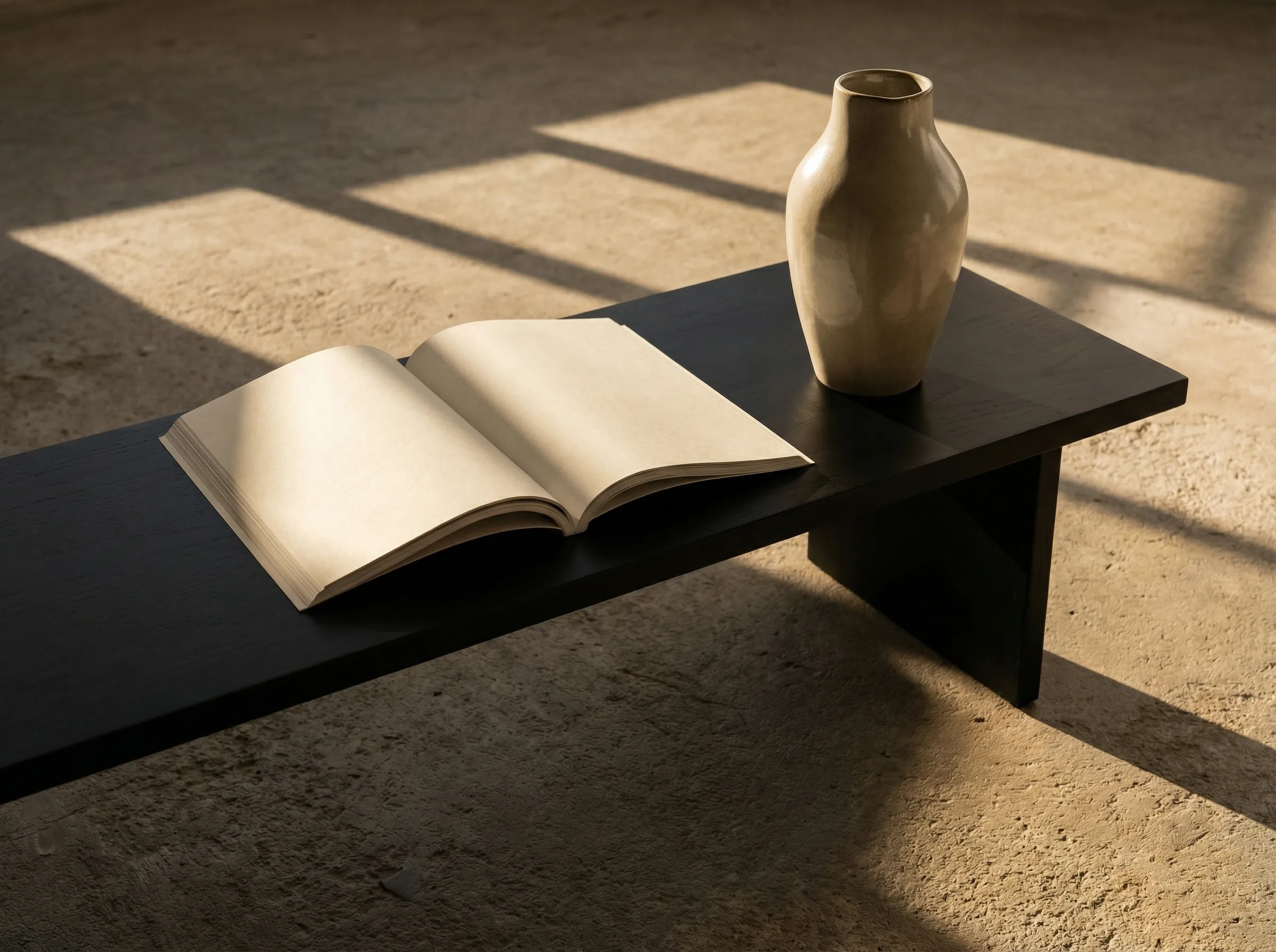 Minimalist book and vase on dark bench