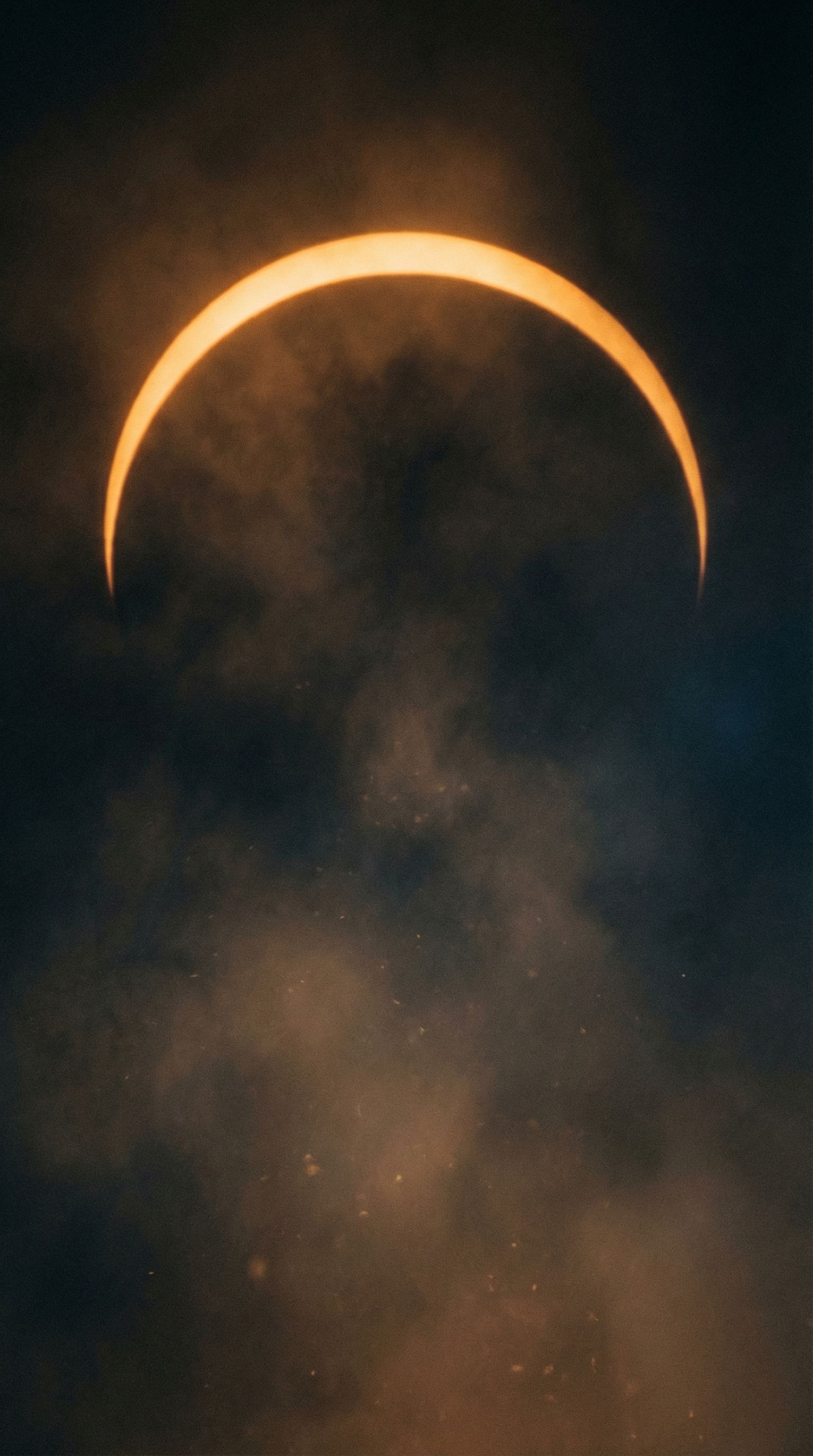 Solar eclipse crescent in smoky night sky