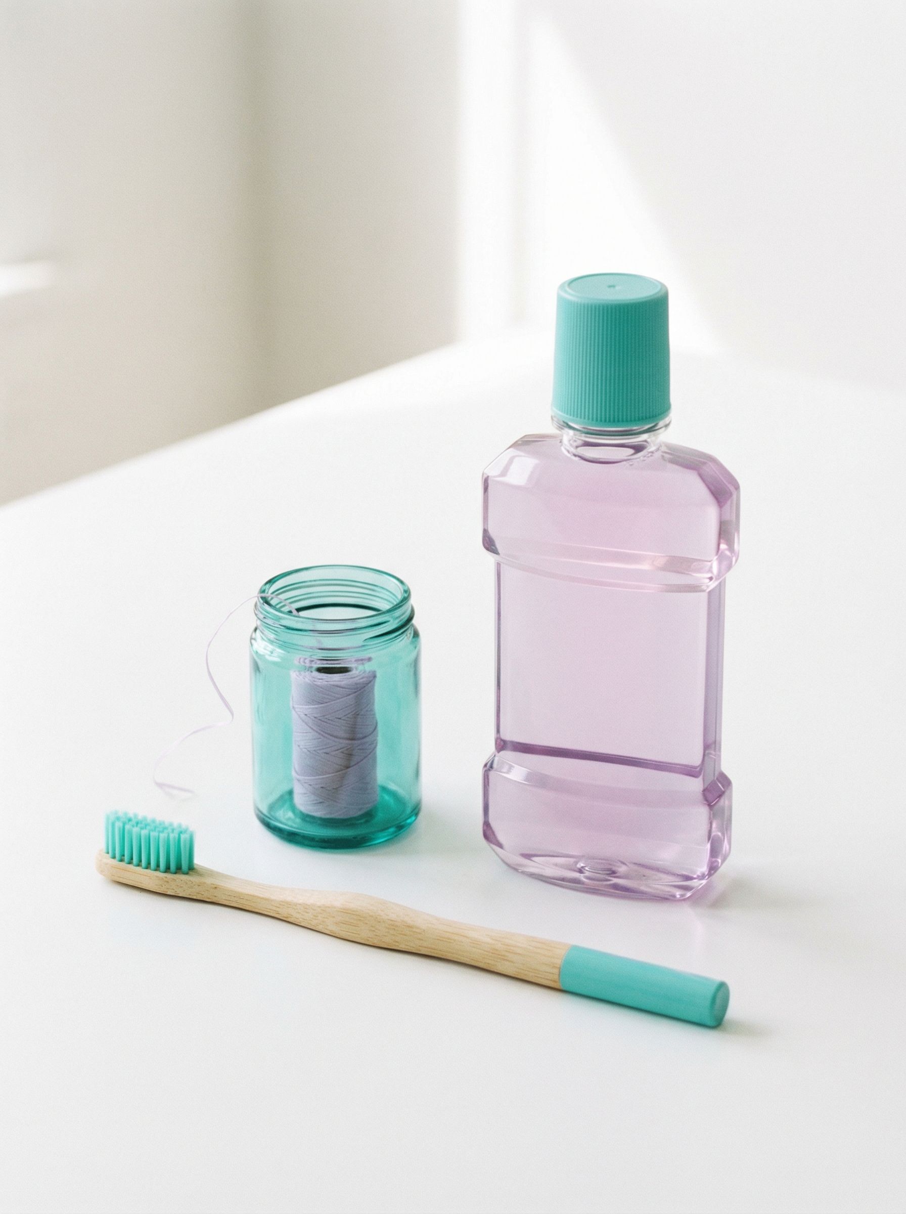 Minimalist dental care products on white surface