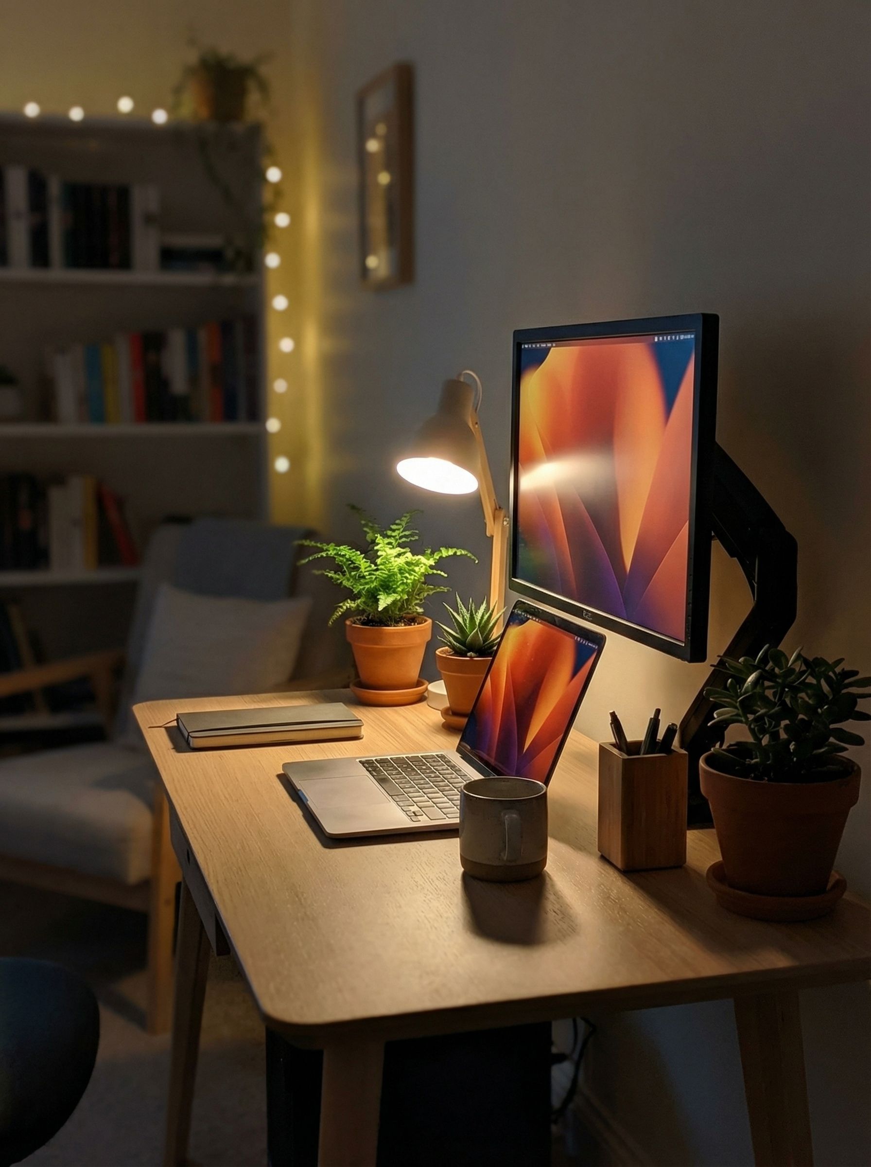 Cozy home office desk with laptop and plants