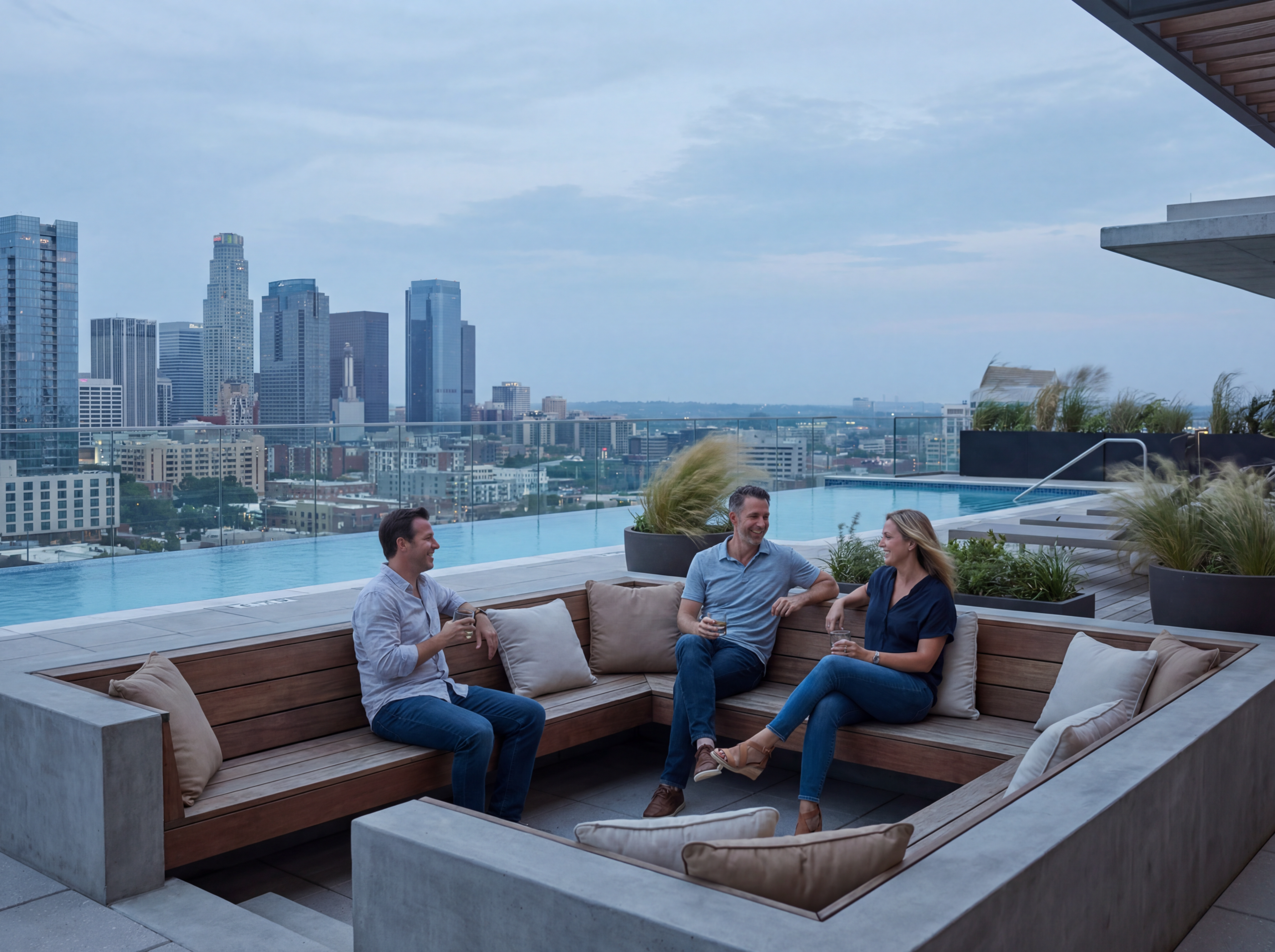 Business colleagues on rooftop lounge at sunset