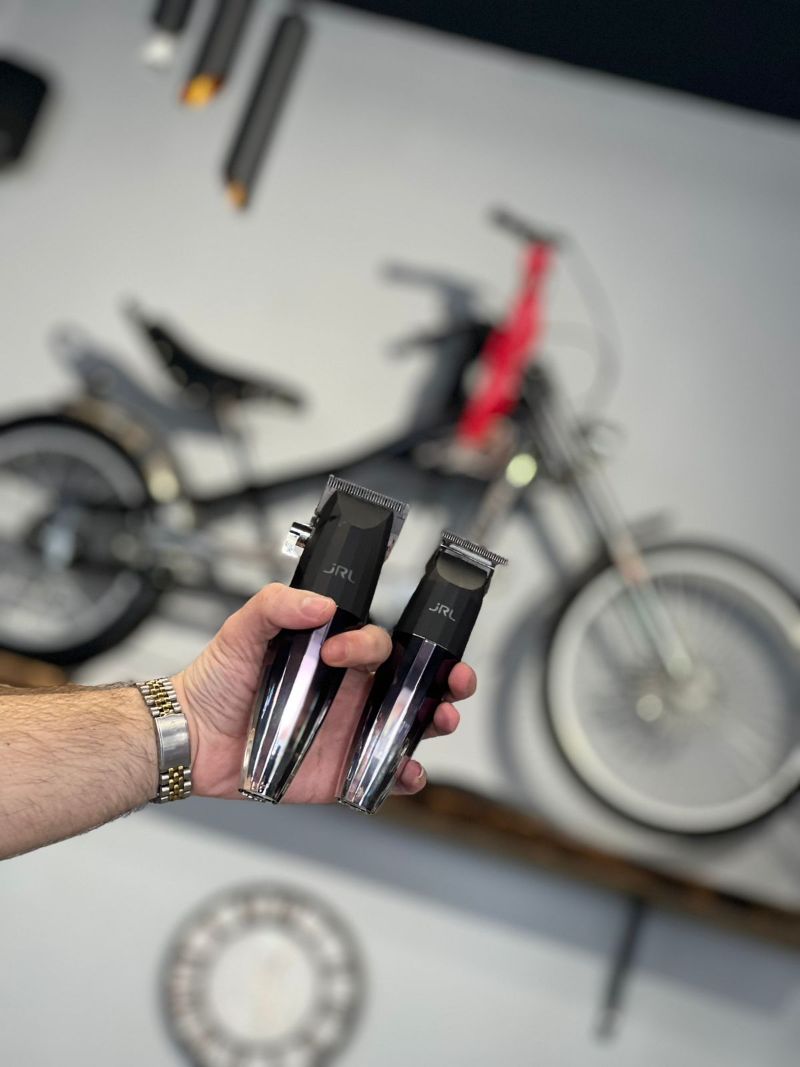 Professional Hair Clippers Held by Barber