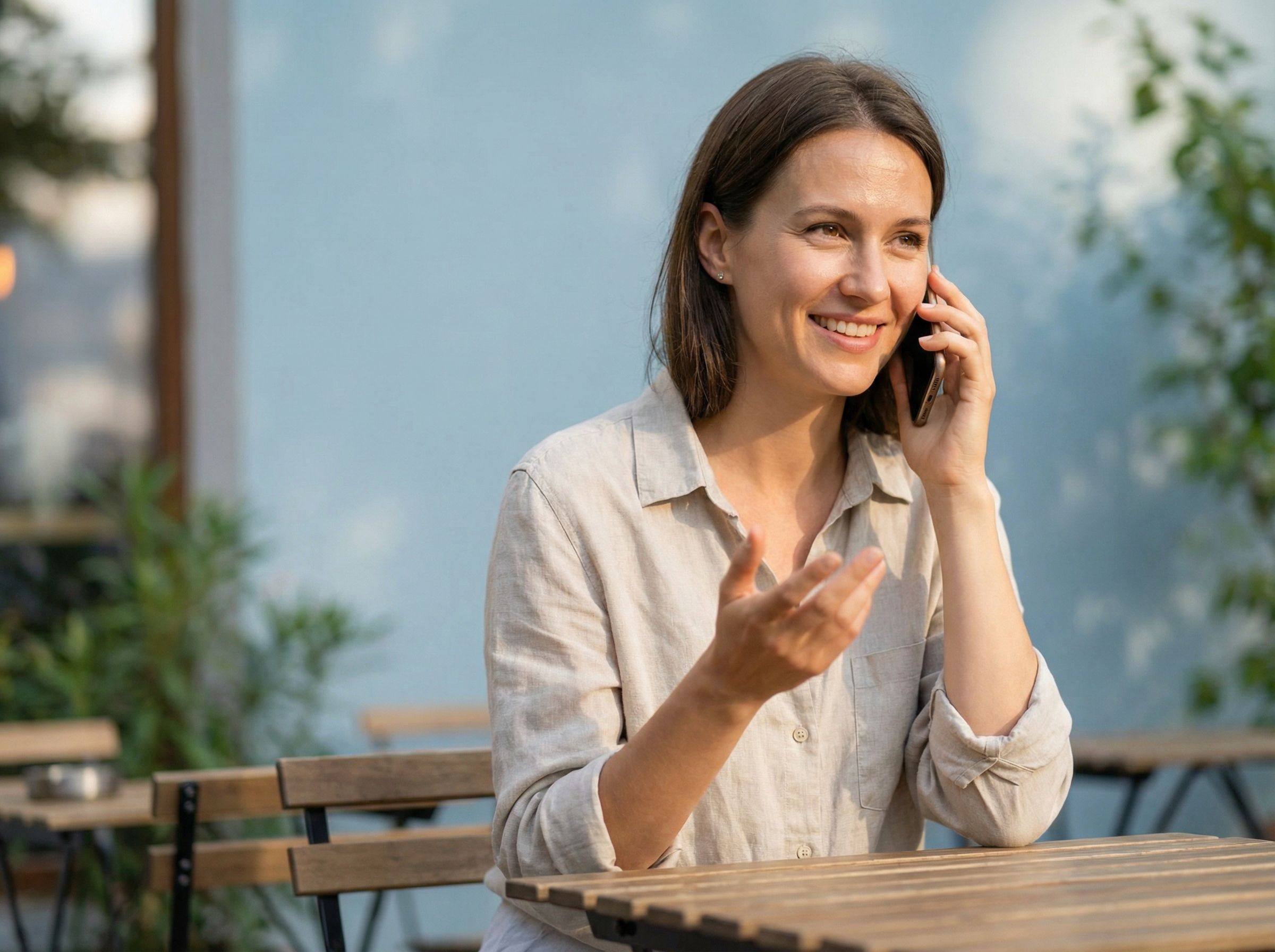 Woman smiling while talking on smartphone outdoors