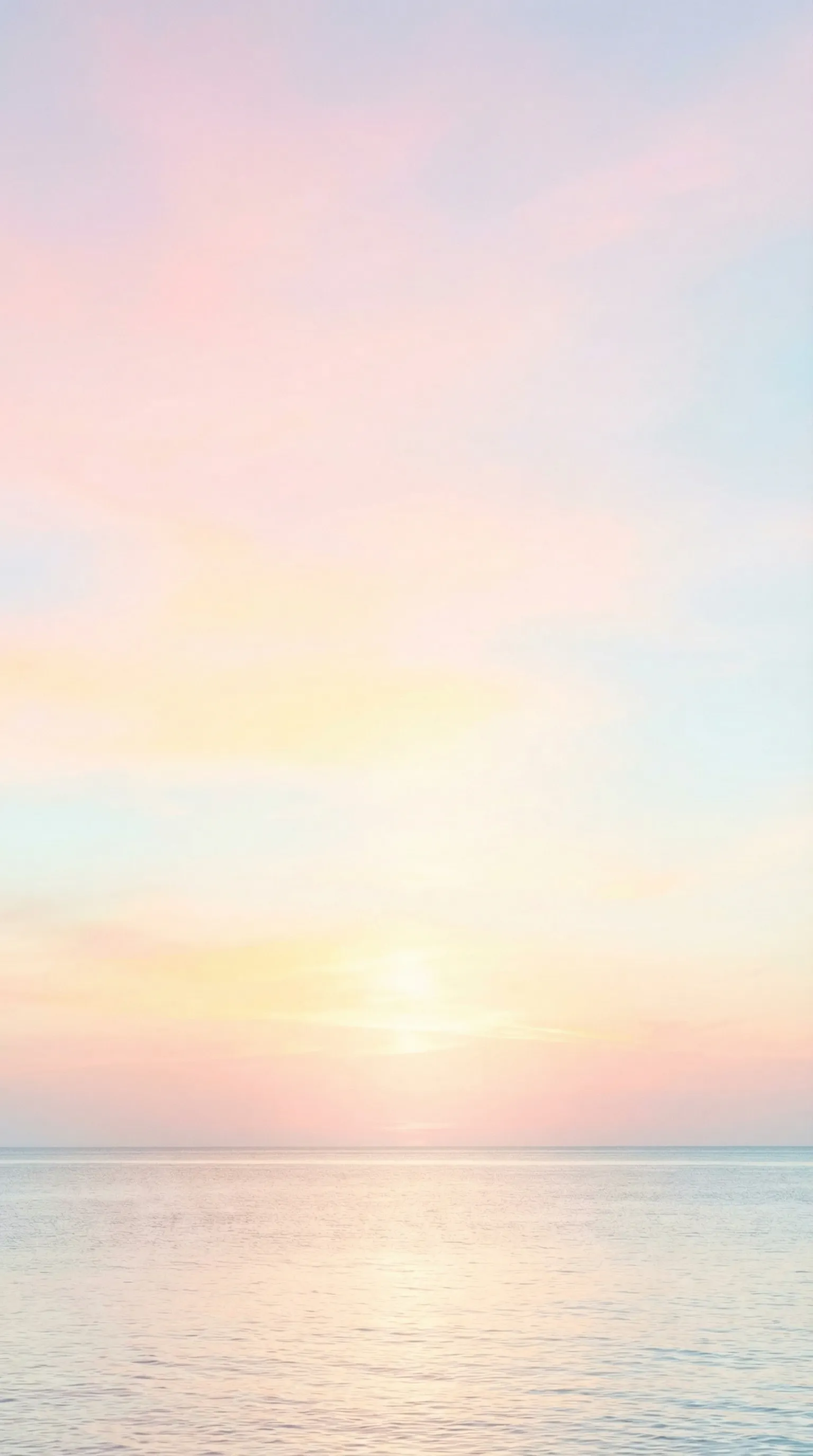 Soft pastel sunset over calm ocean