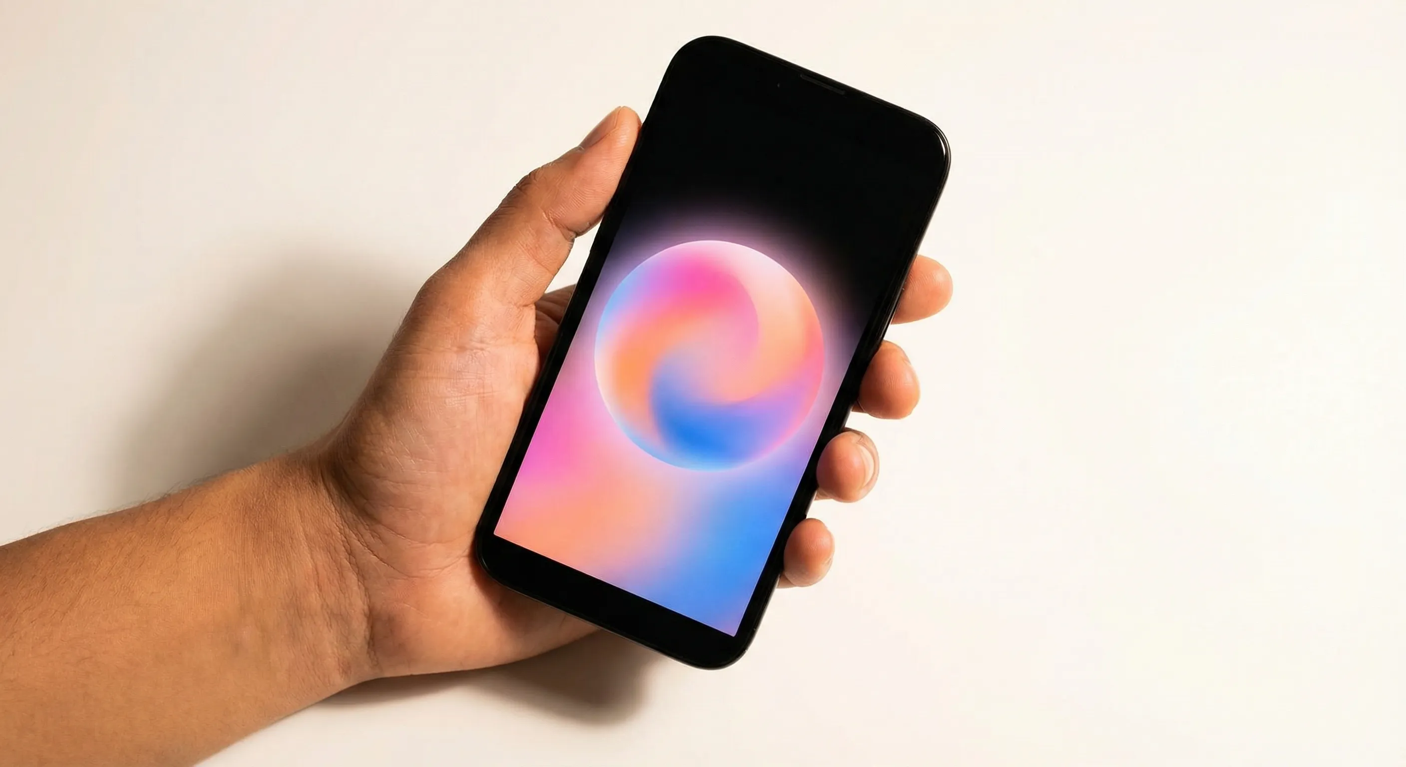 Hand holding smartphone with colorful screen