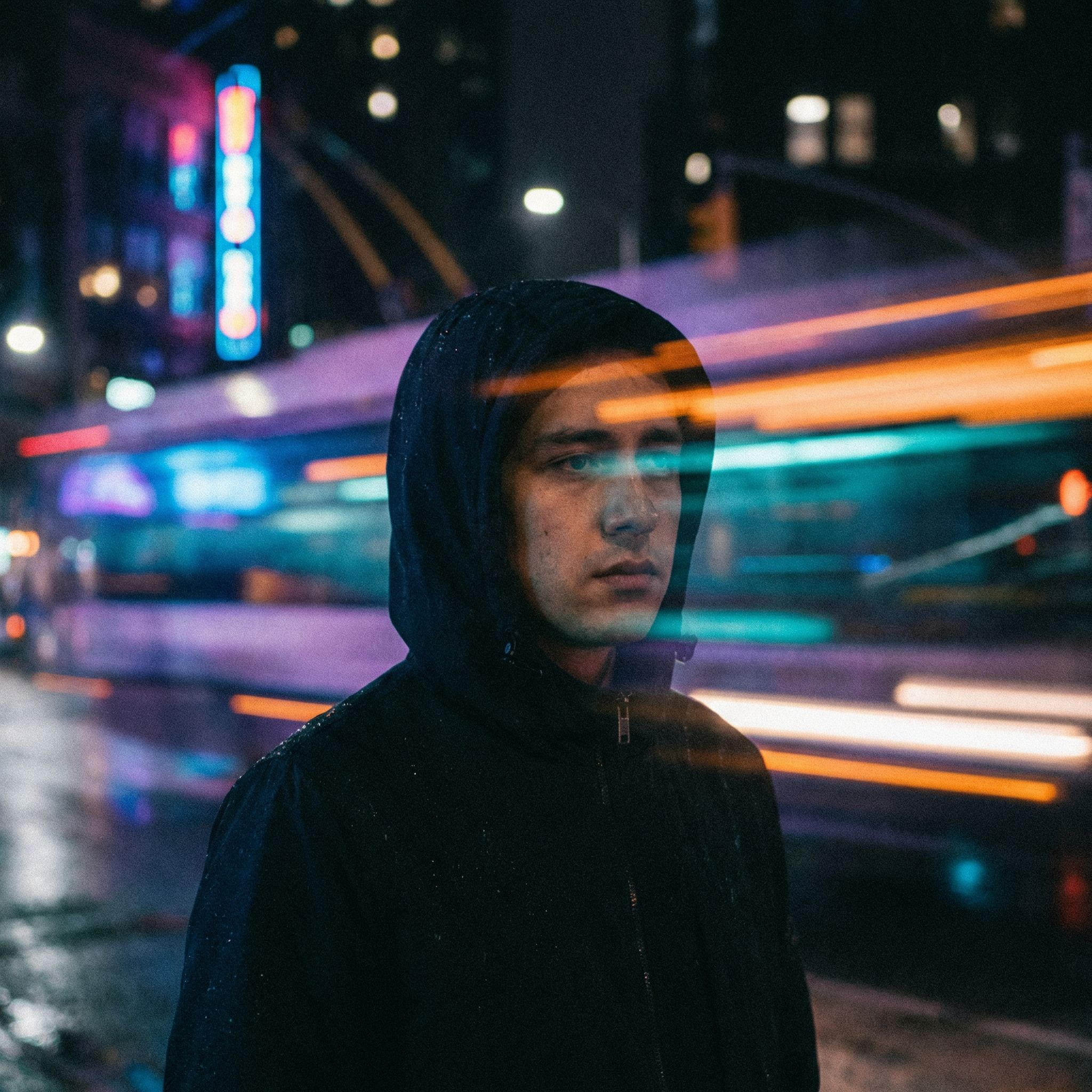 Moody urban portrait at night with neon lights