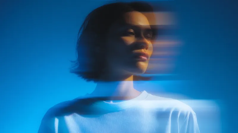 Abstract motion-blur portrait on blue backdrop