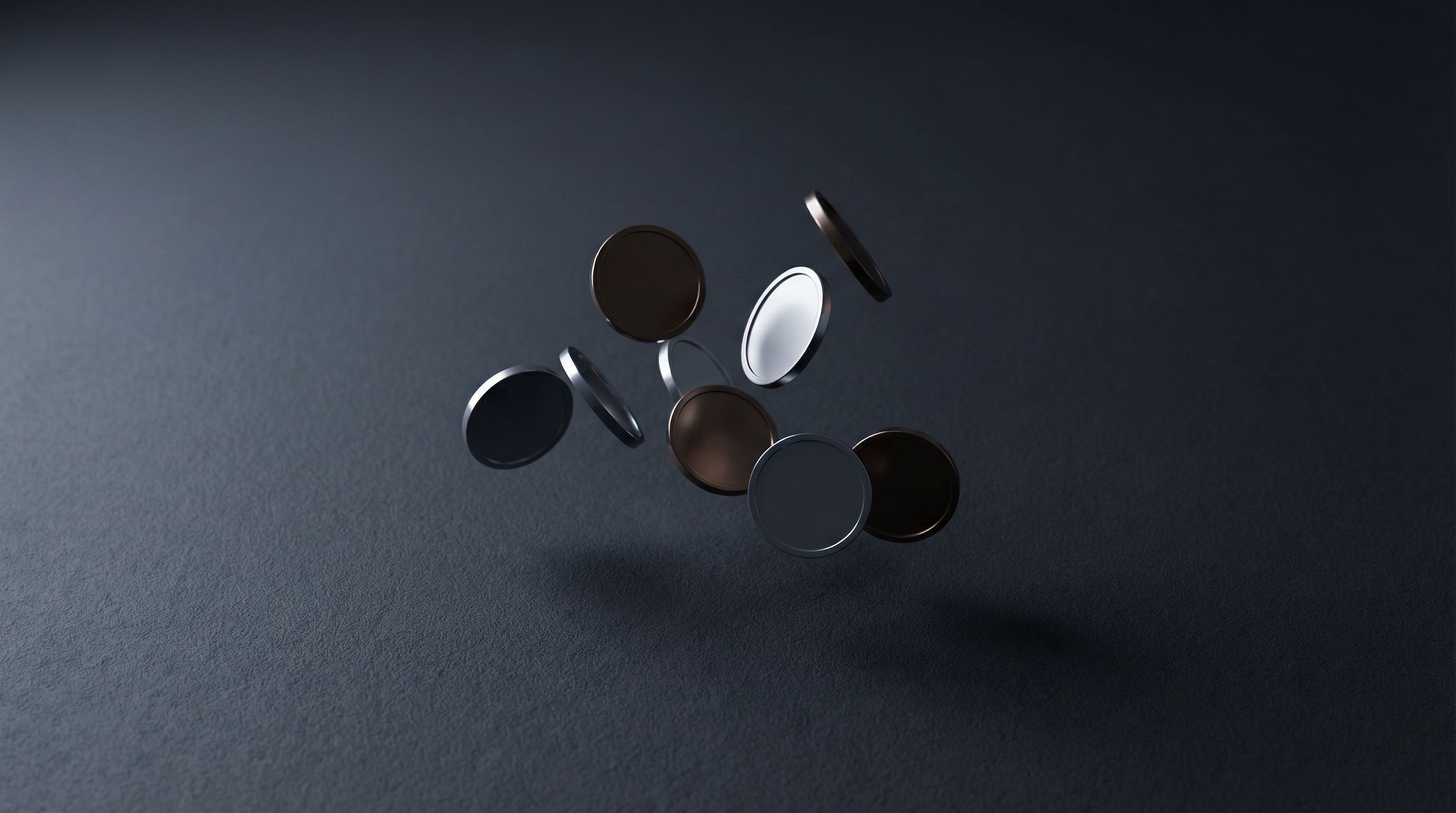Floating metallic coins on dark background