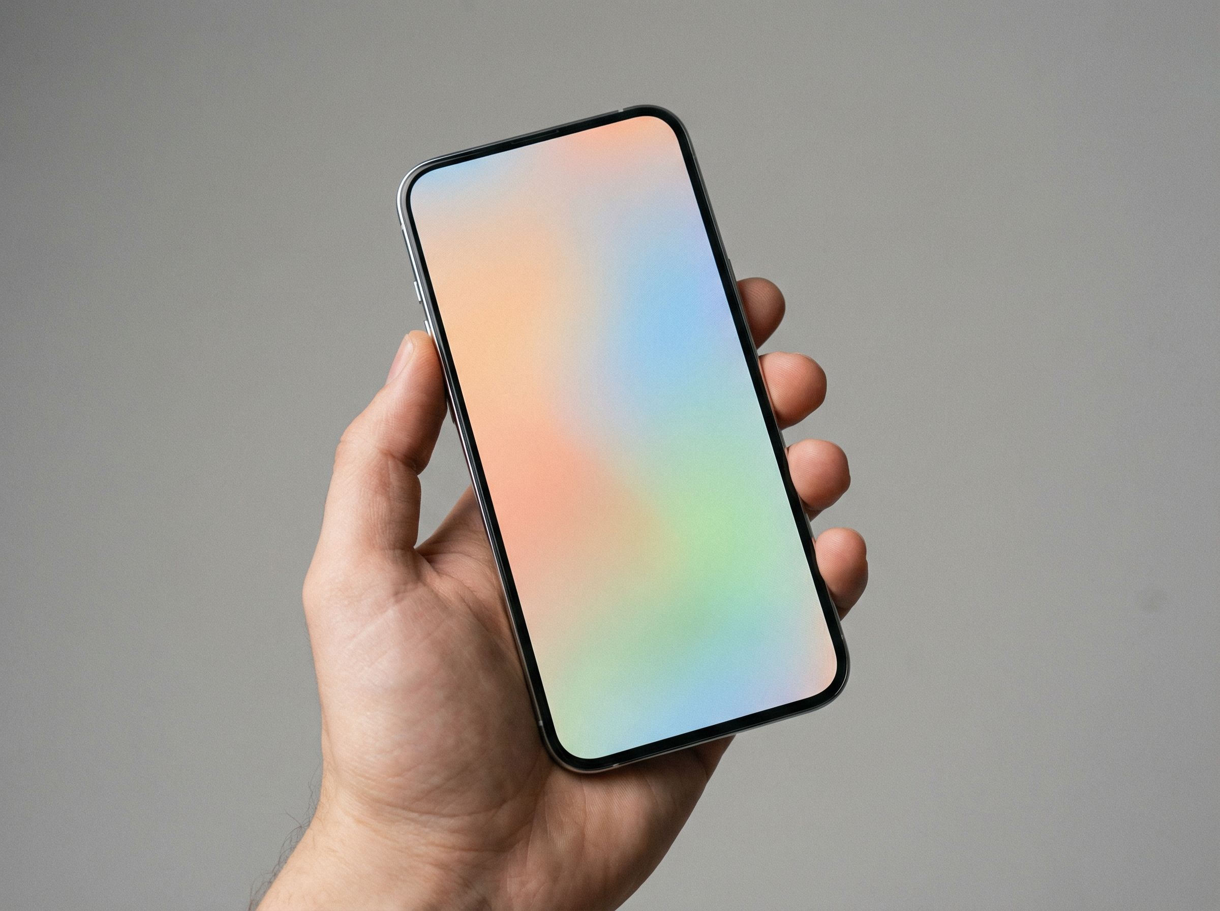 Hand holding smartphone with pastel screen