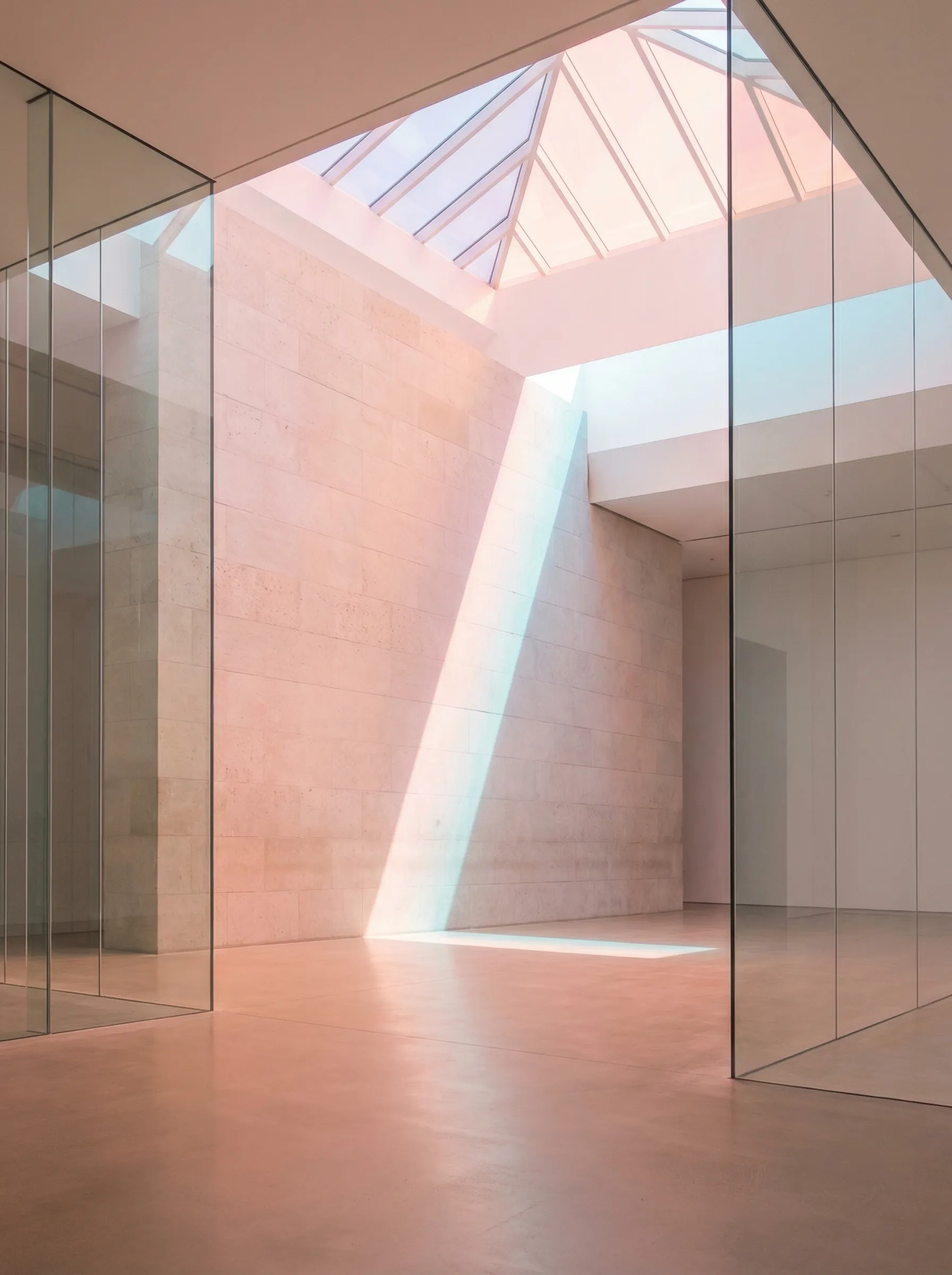 Minimalist atrium with glass walls and skylight