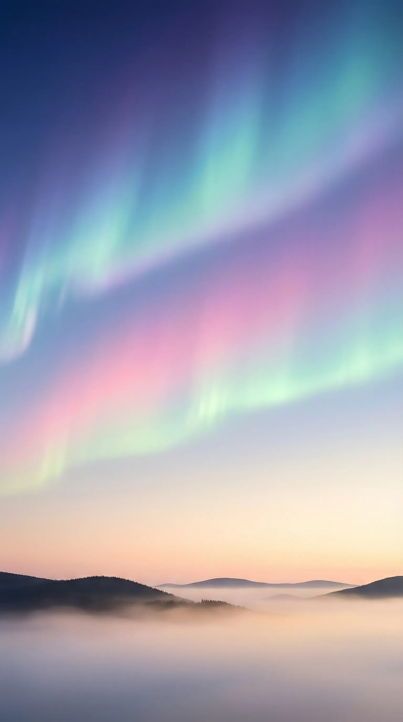 Pastel aurora over misty mountain valley