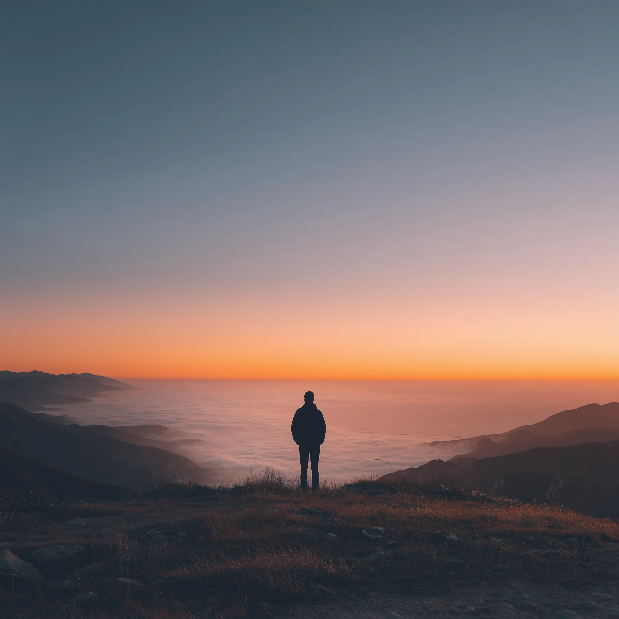 Silhouette Overlooking Clouds at Sunset