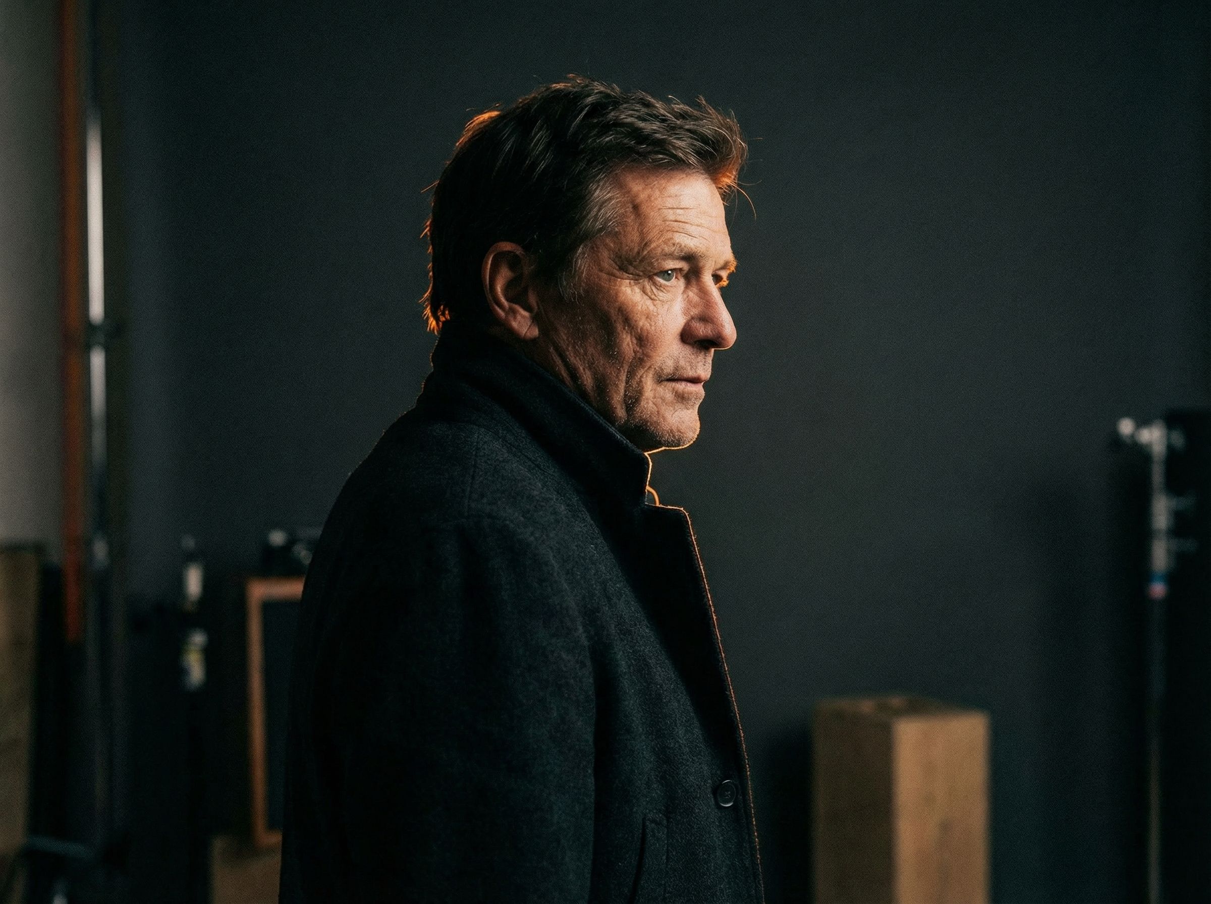 Moody side portrait of mature man in coat