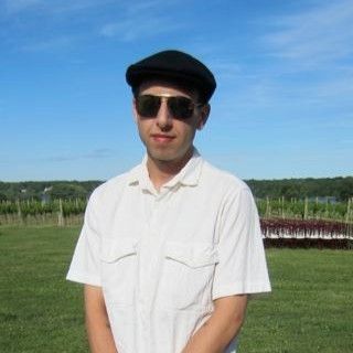 Man in Sunglasses and Flat Cap in Vineyard