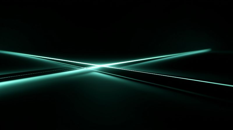 Intersecting teal laser beams on dark background