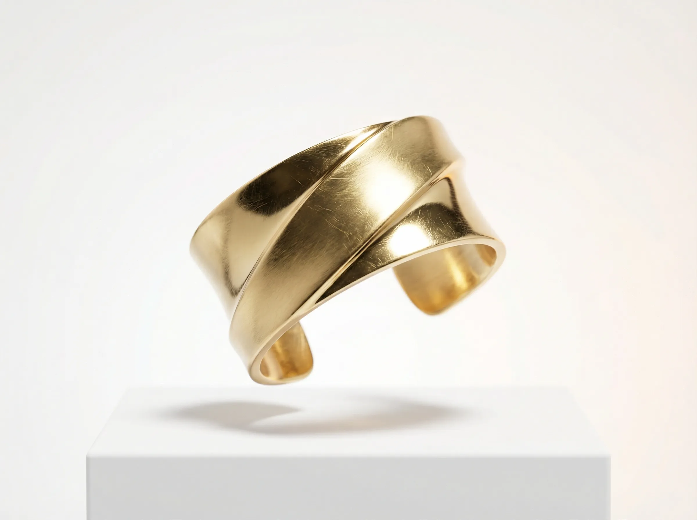 Minimalist gold cuff bracelet on pedestal