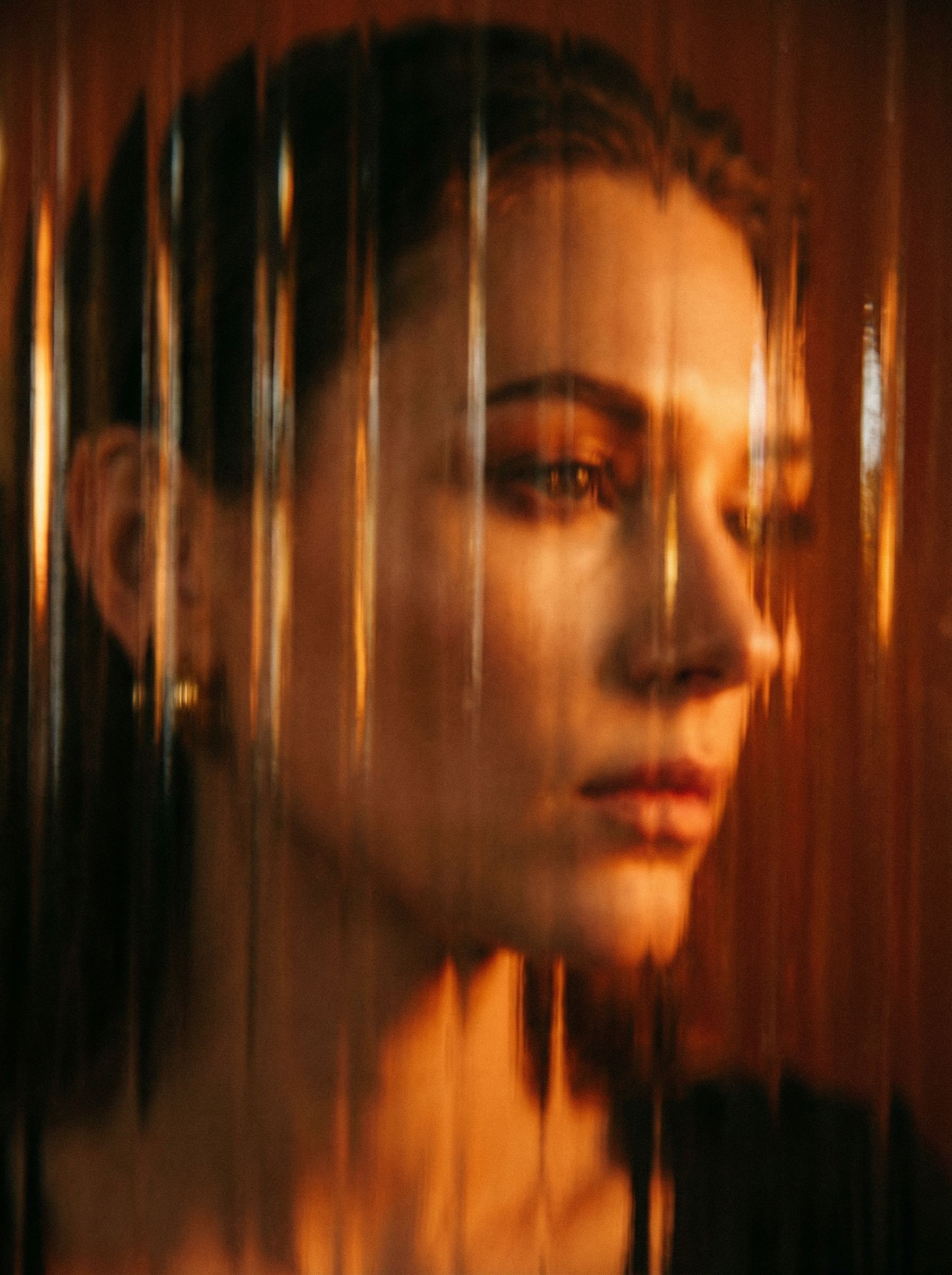 Abstract portrait behind textured glass