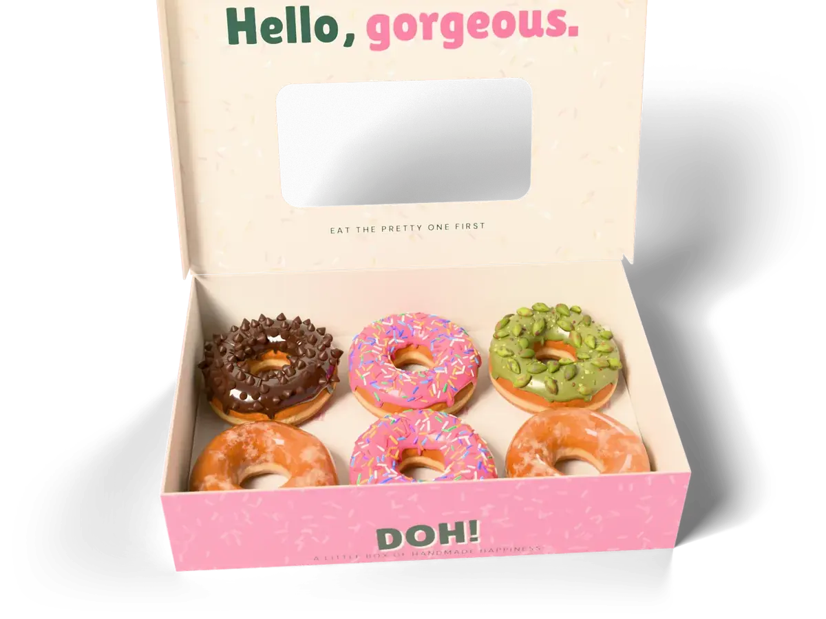 An open pink DOH! box holding six donuts, with Hello, gorgeous. printed inside the lid