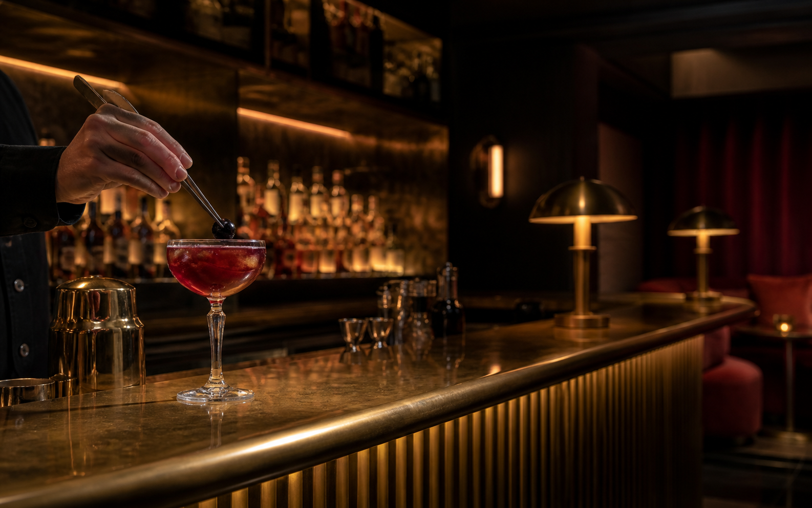 Bartender finishing a signature cocktail at the private cinema bar