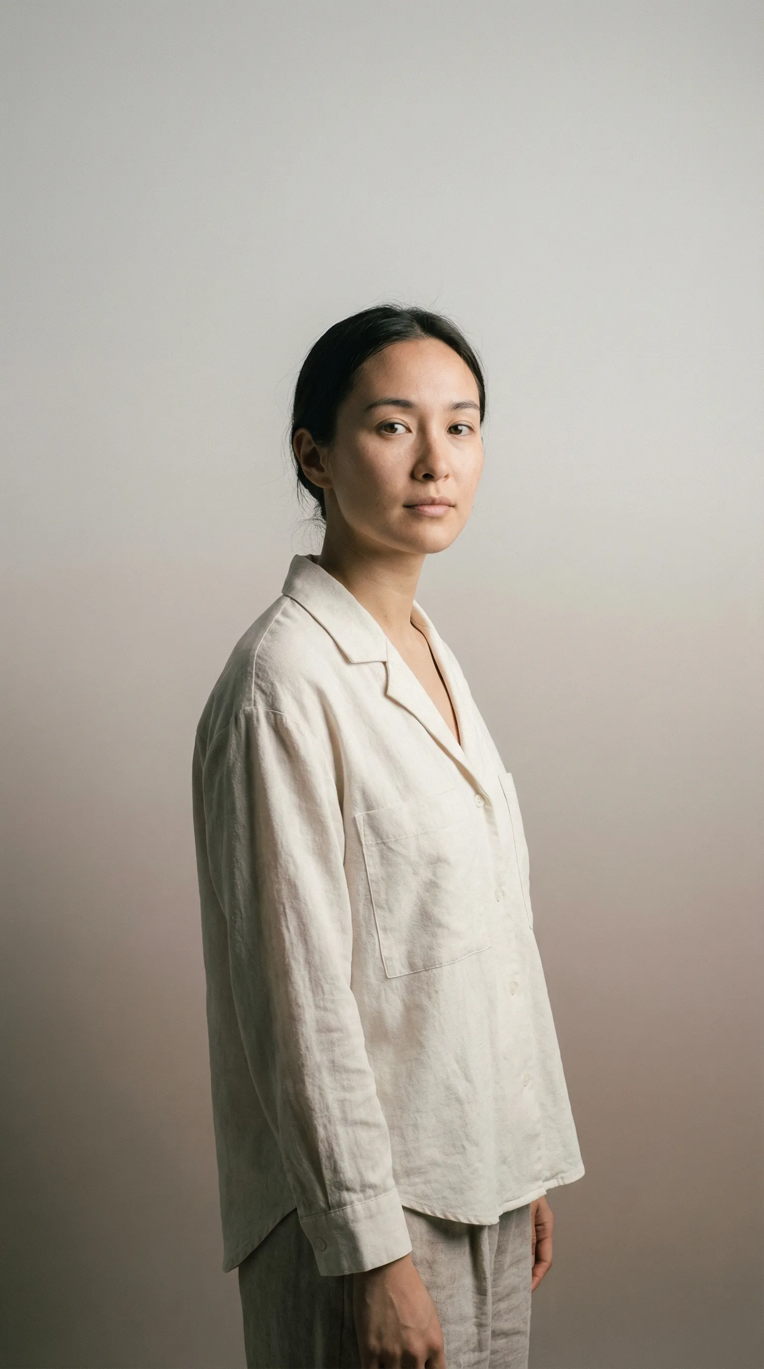 Minimalist studio portrait of person in linen