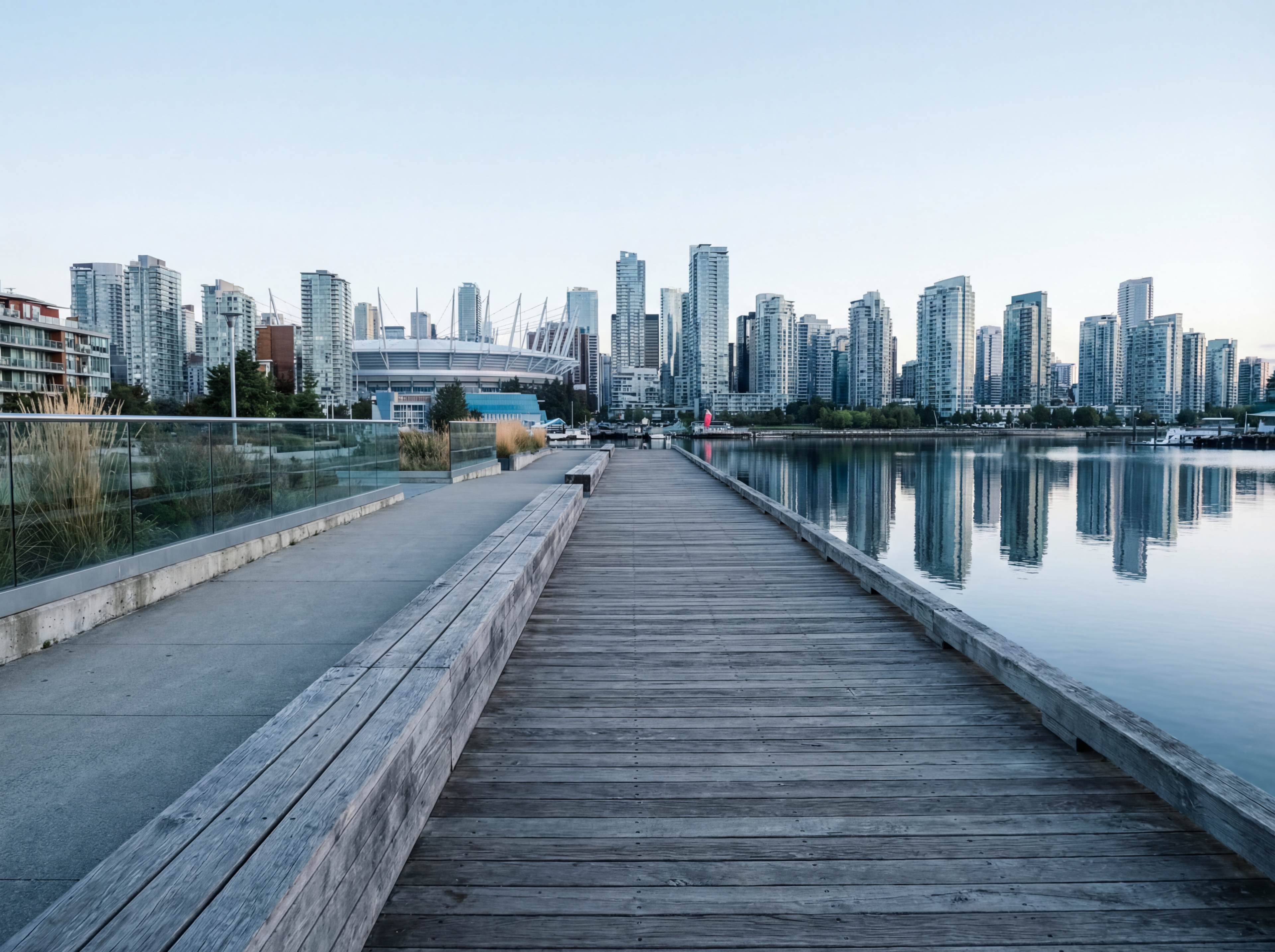 Waterfront boardwalk with modern city skyline
