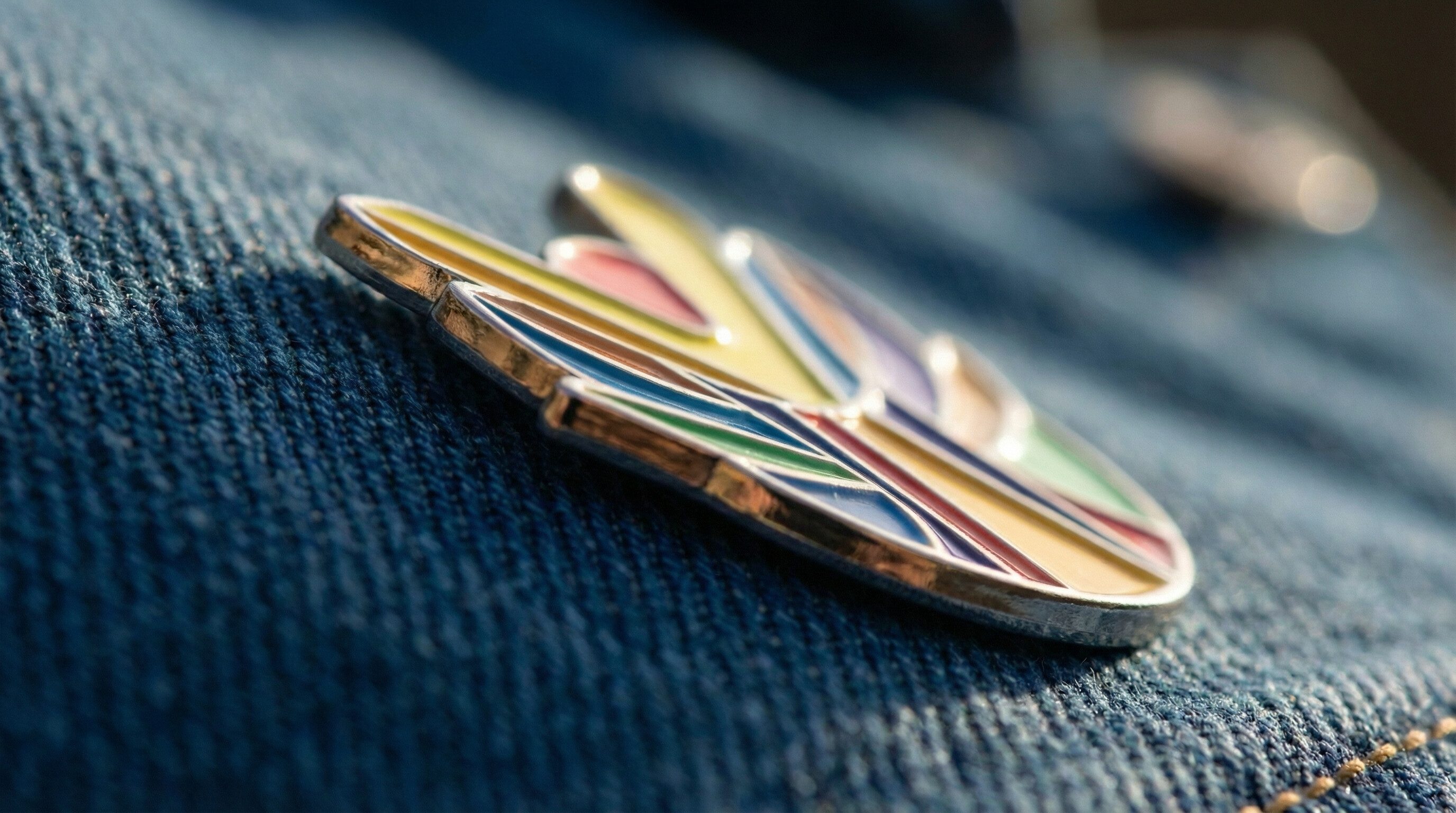 Colorful enamel pin on denim fabric