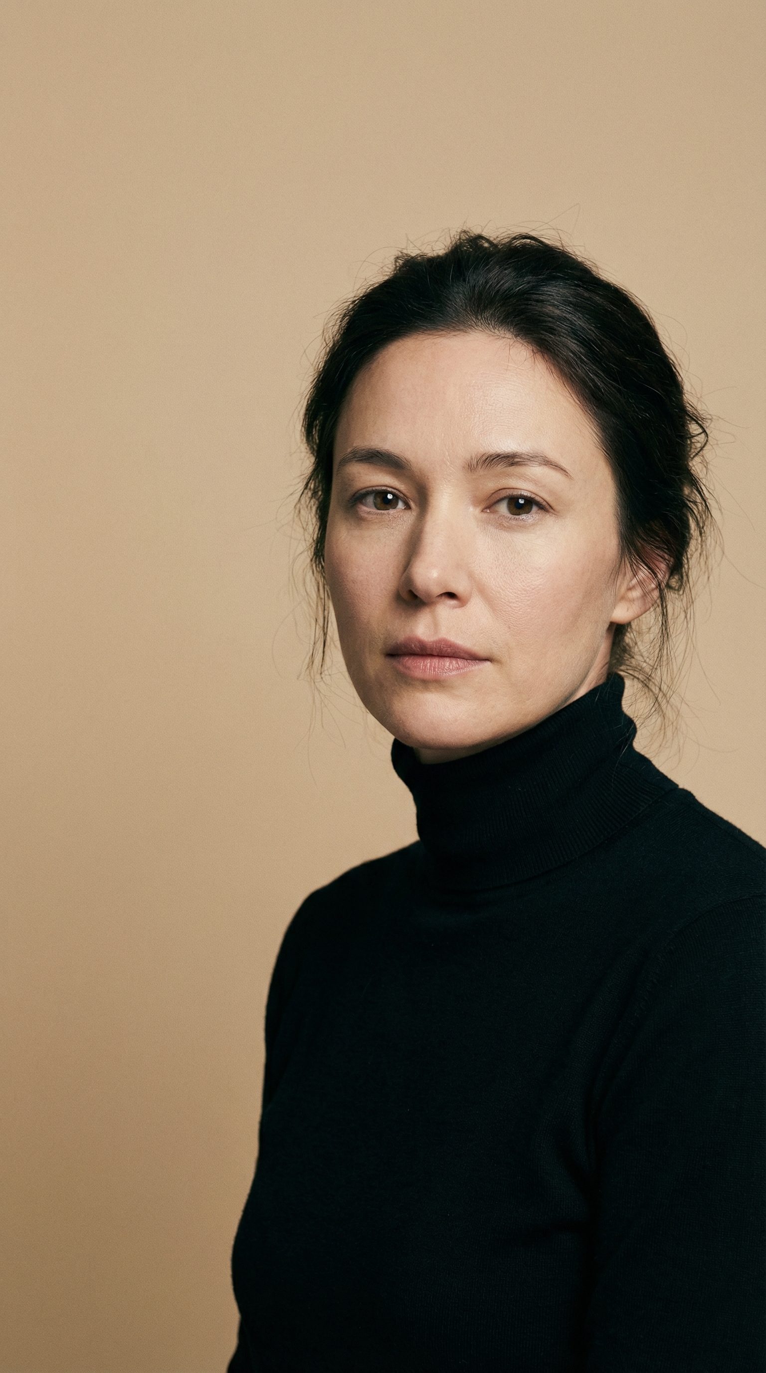 Studio portrait of woman in black turtleneck