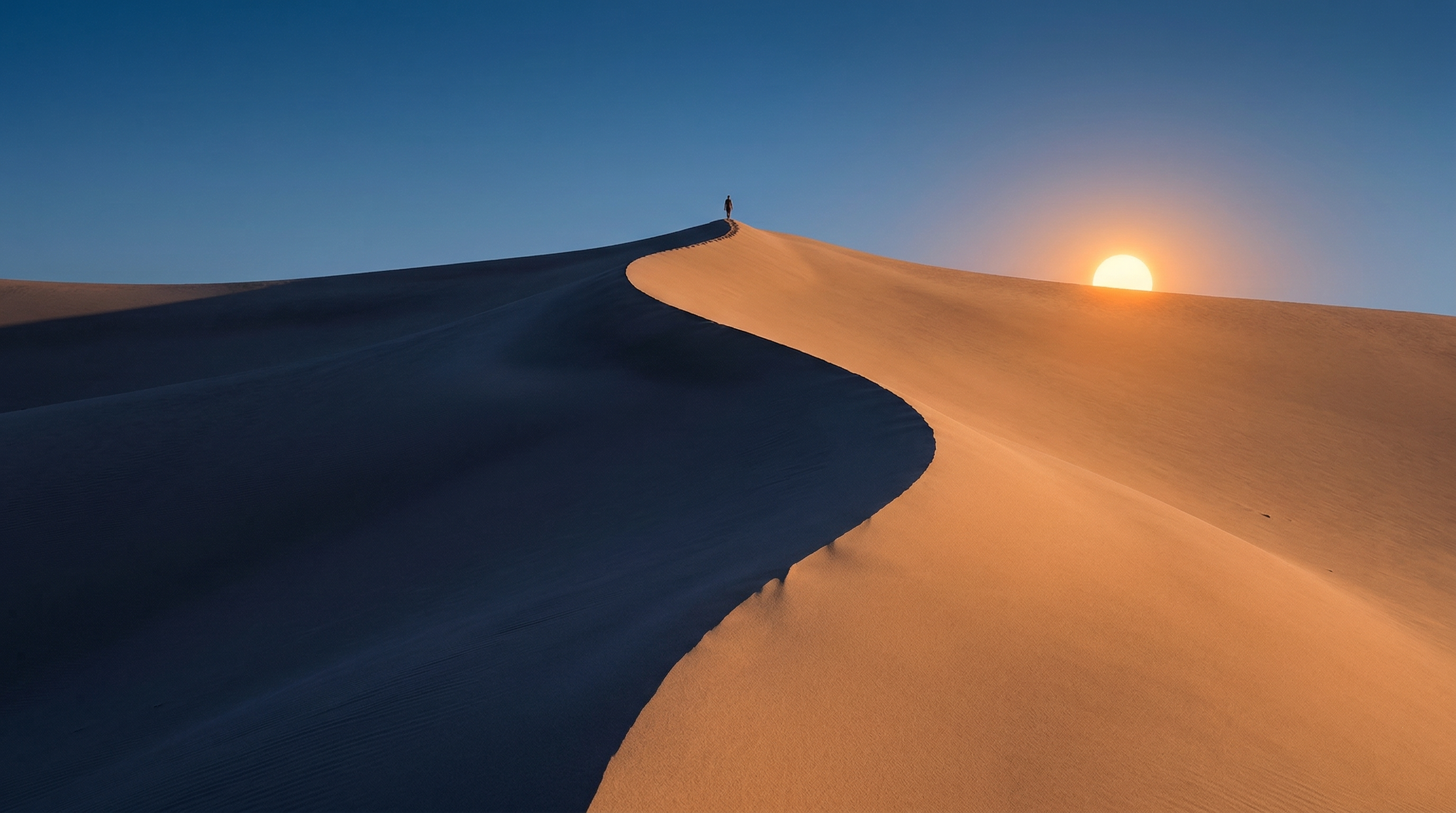 Solitary Figure on Desert Dune at Sunset