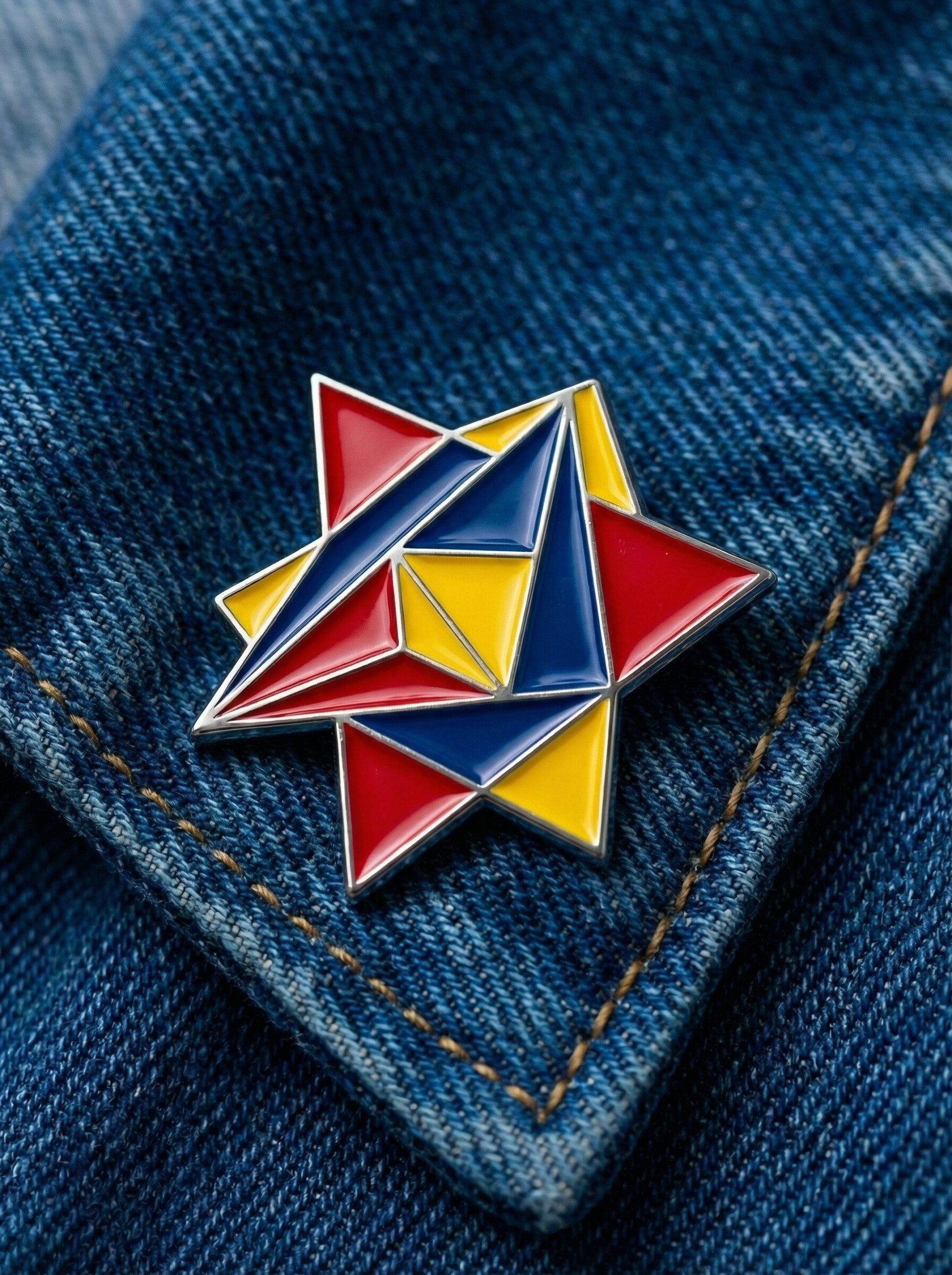 Geometric enamel star pin on denim