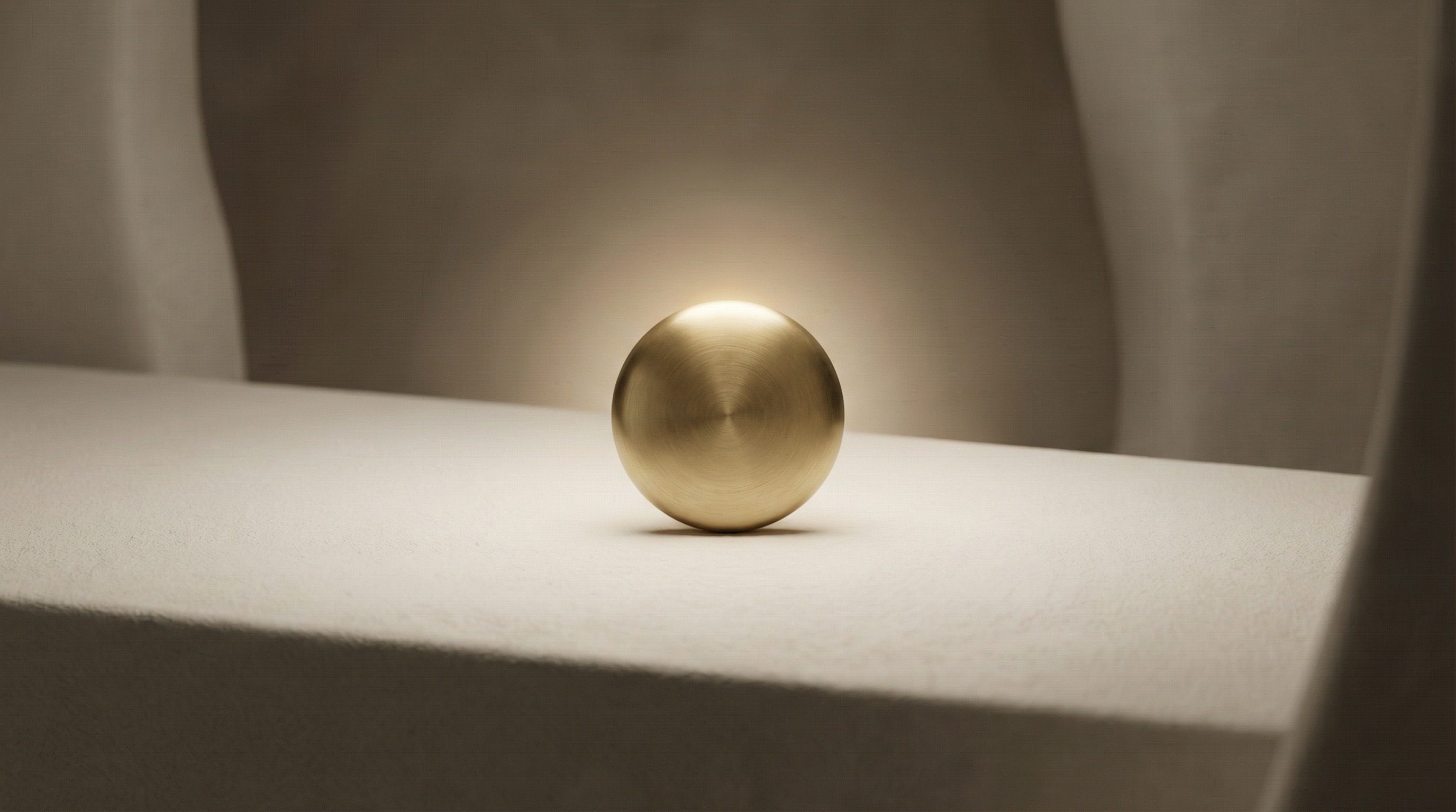 Minimalist brass sphere on neutral surface