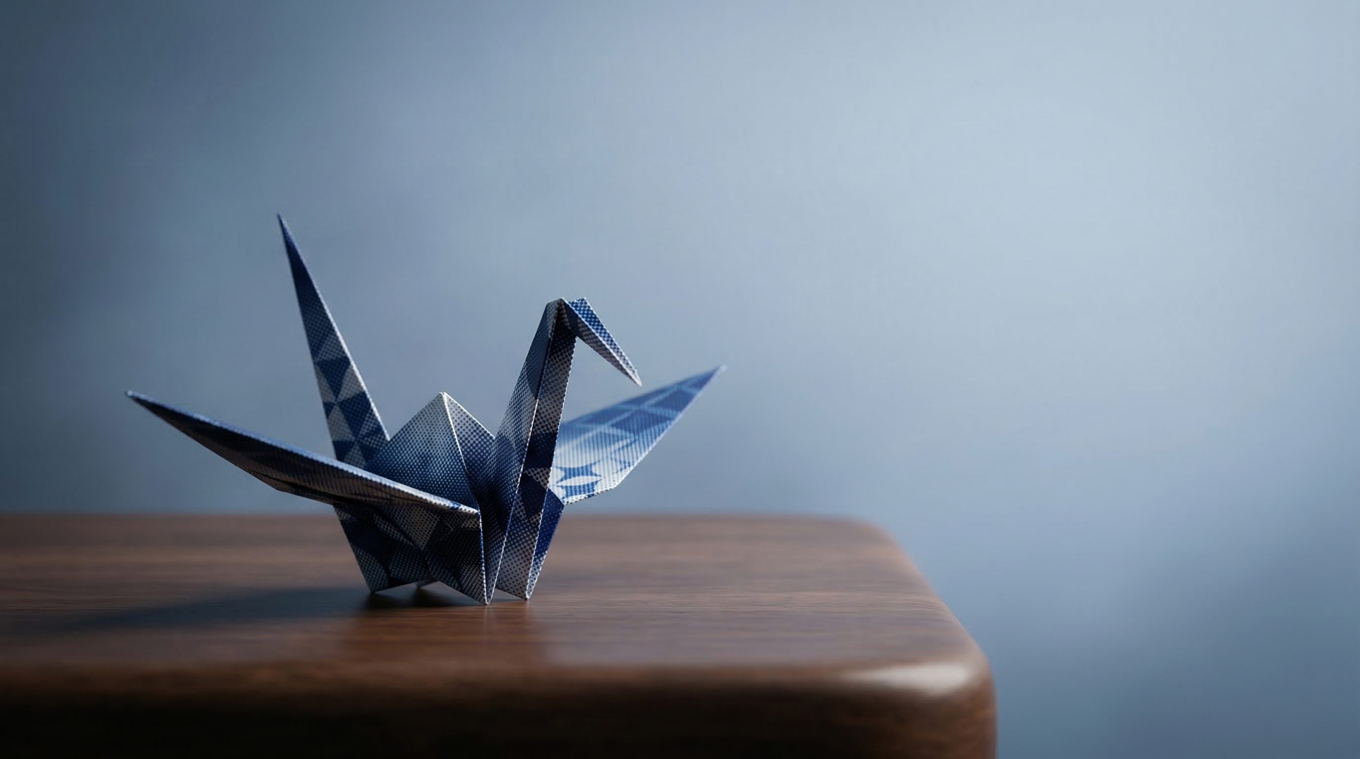 Blue Origami Crane on Wooden Table
