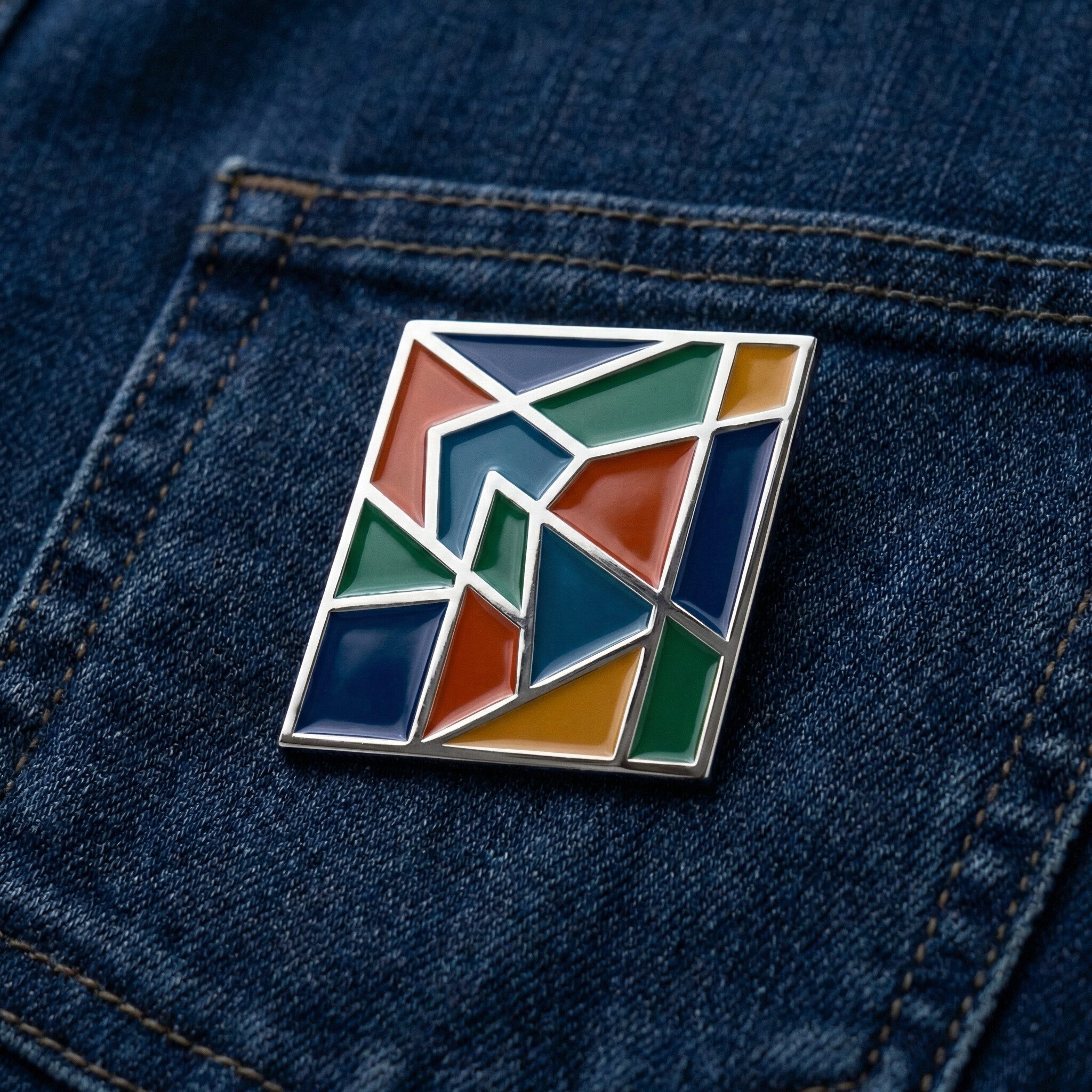 Geometric enamel pin on denim pocket