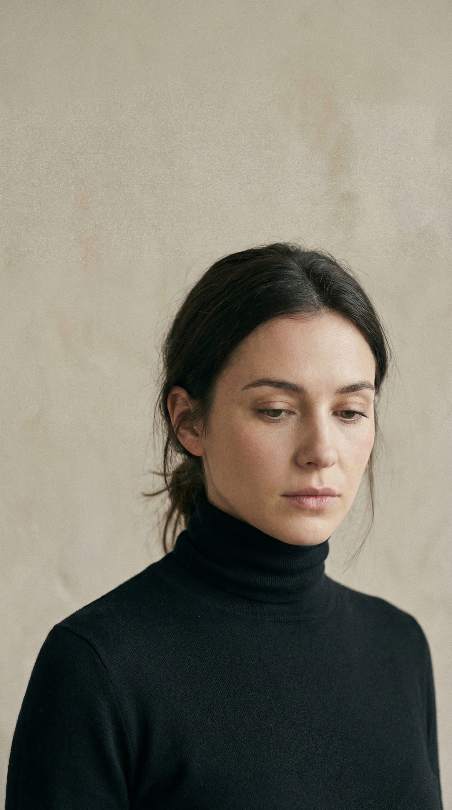 Pensive woman in black turtleneck portrait