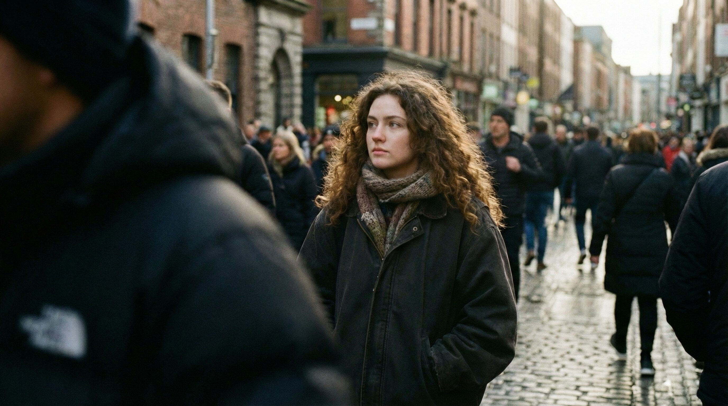 Thoughtful woman walking in busy city street