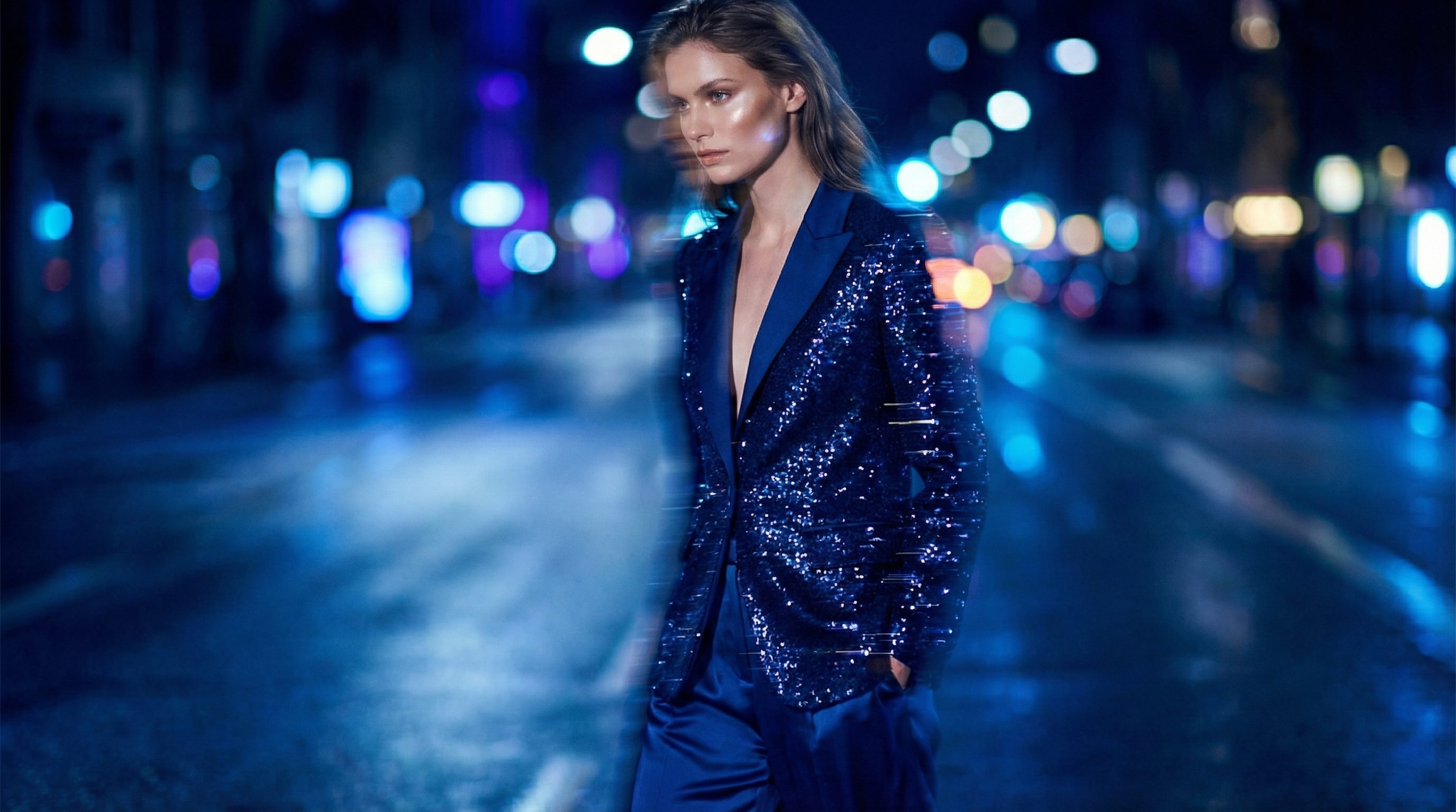 Fashion model in blue sequin suit at night