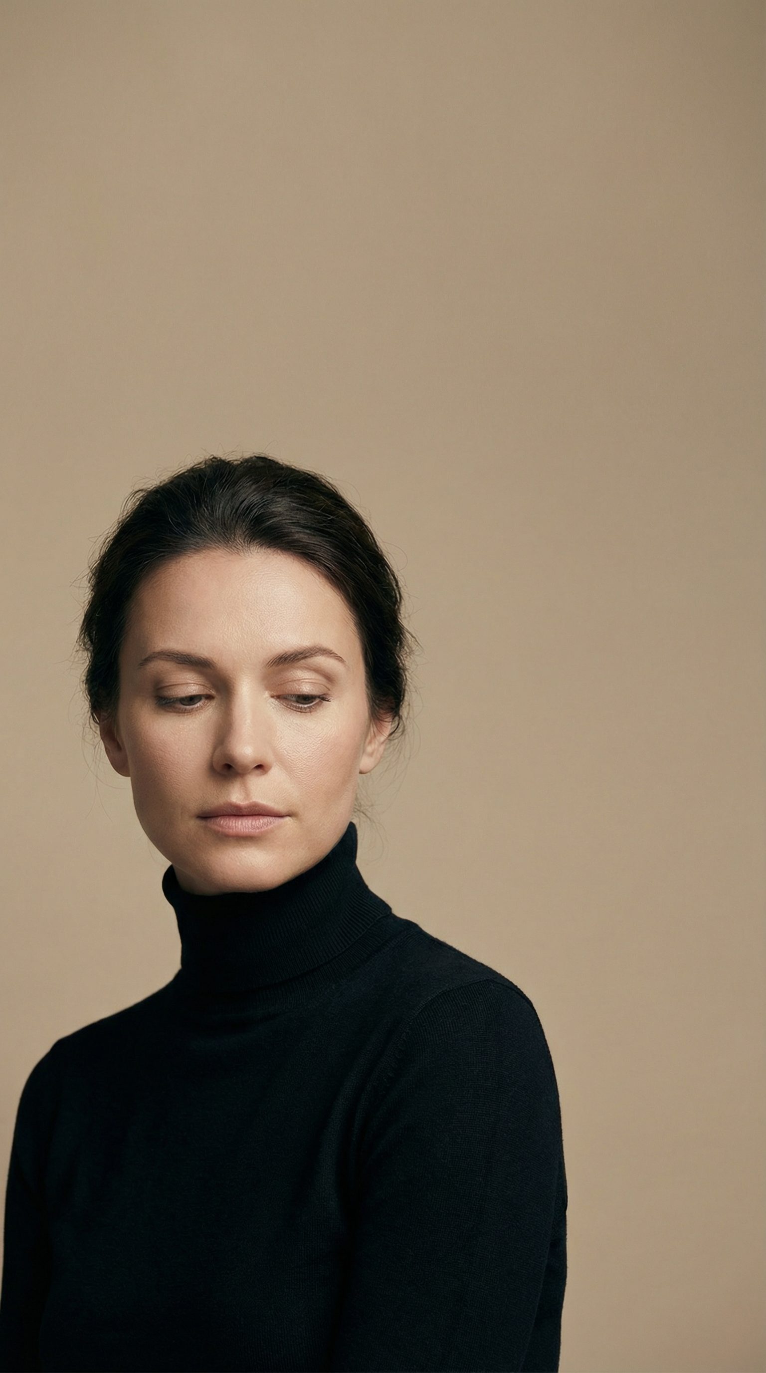 Pensive woman in black turtleneck portrait