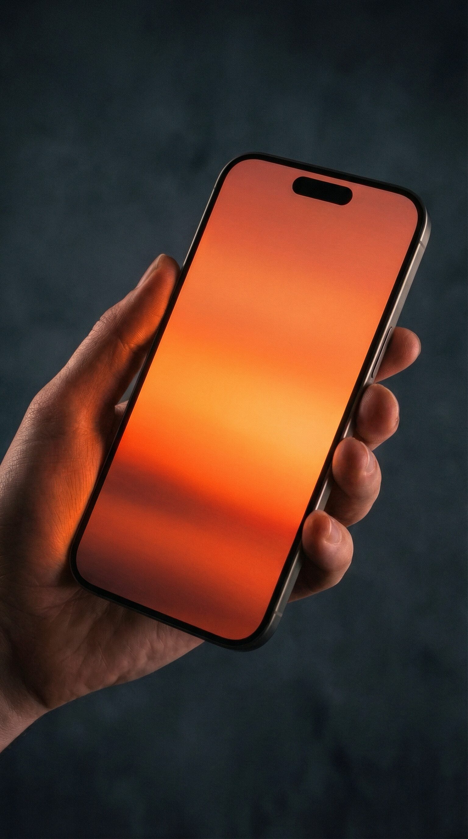 Hand holding smartphone with orange screen