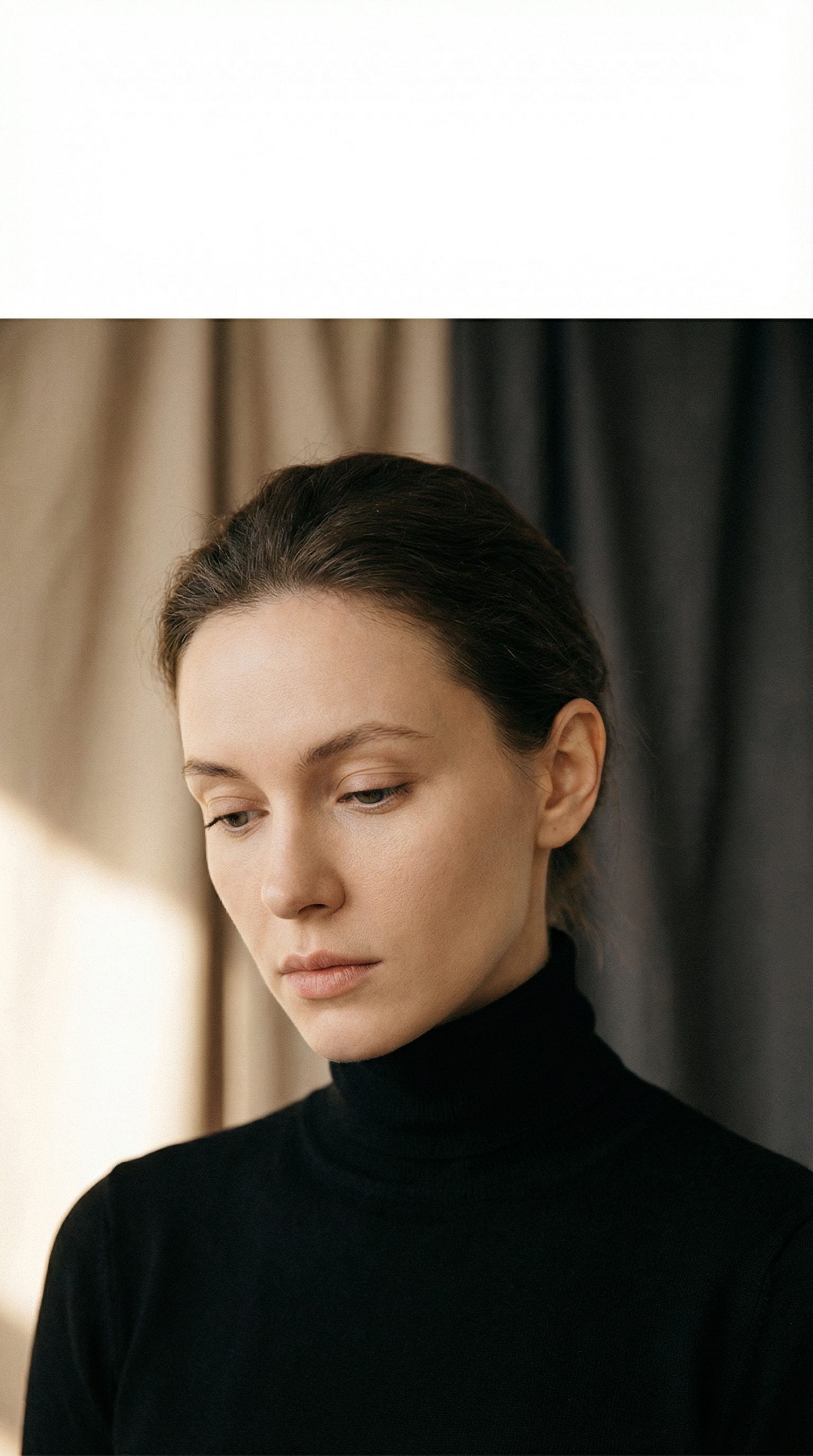 Pensive woman in black turtleneck portrait