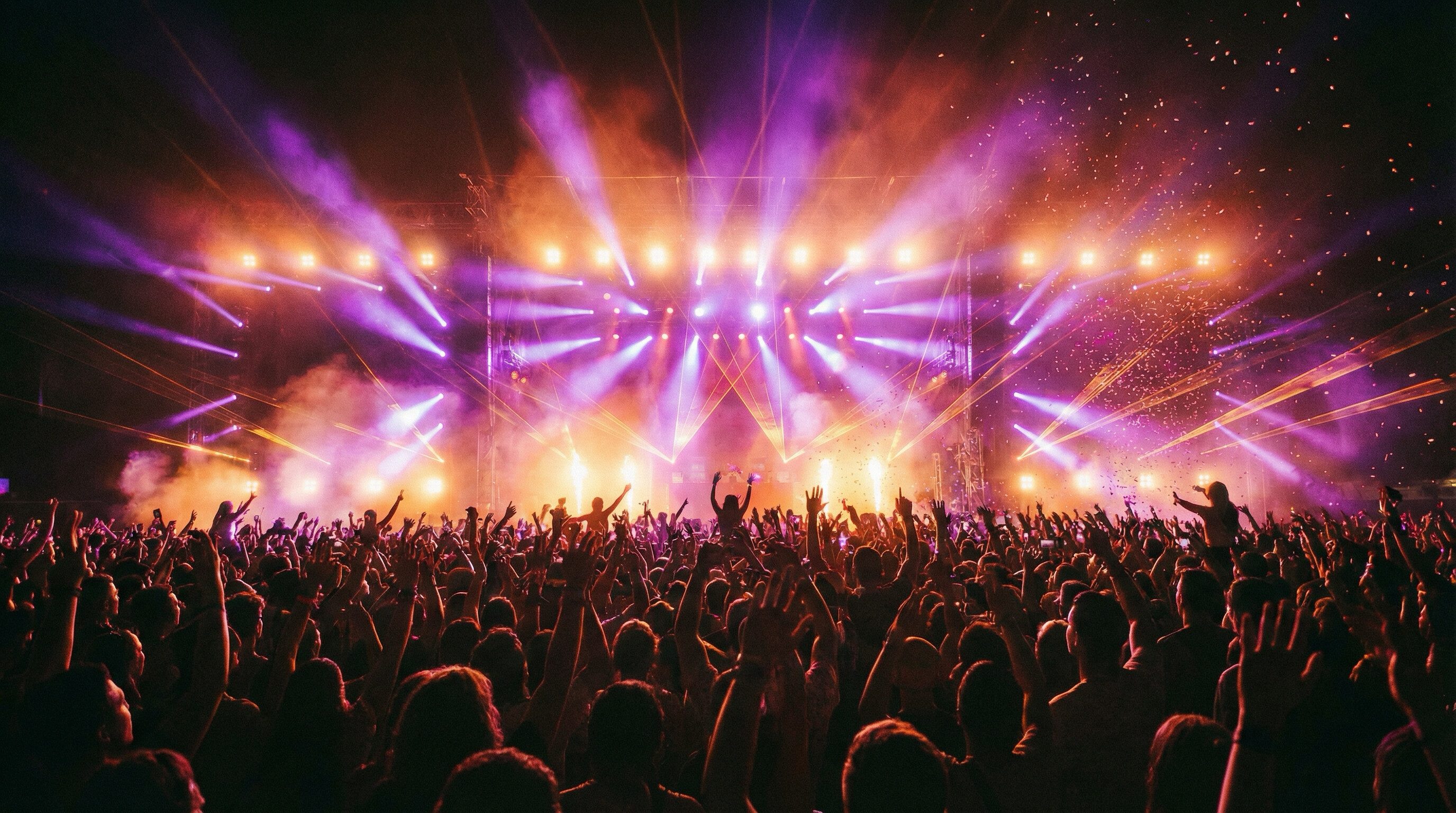 Crowd at night music festival with stage lights