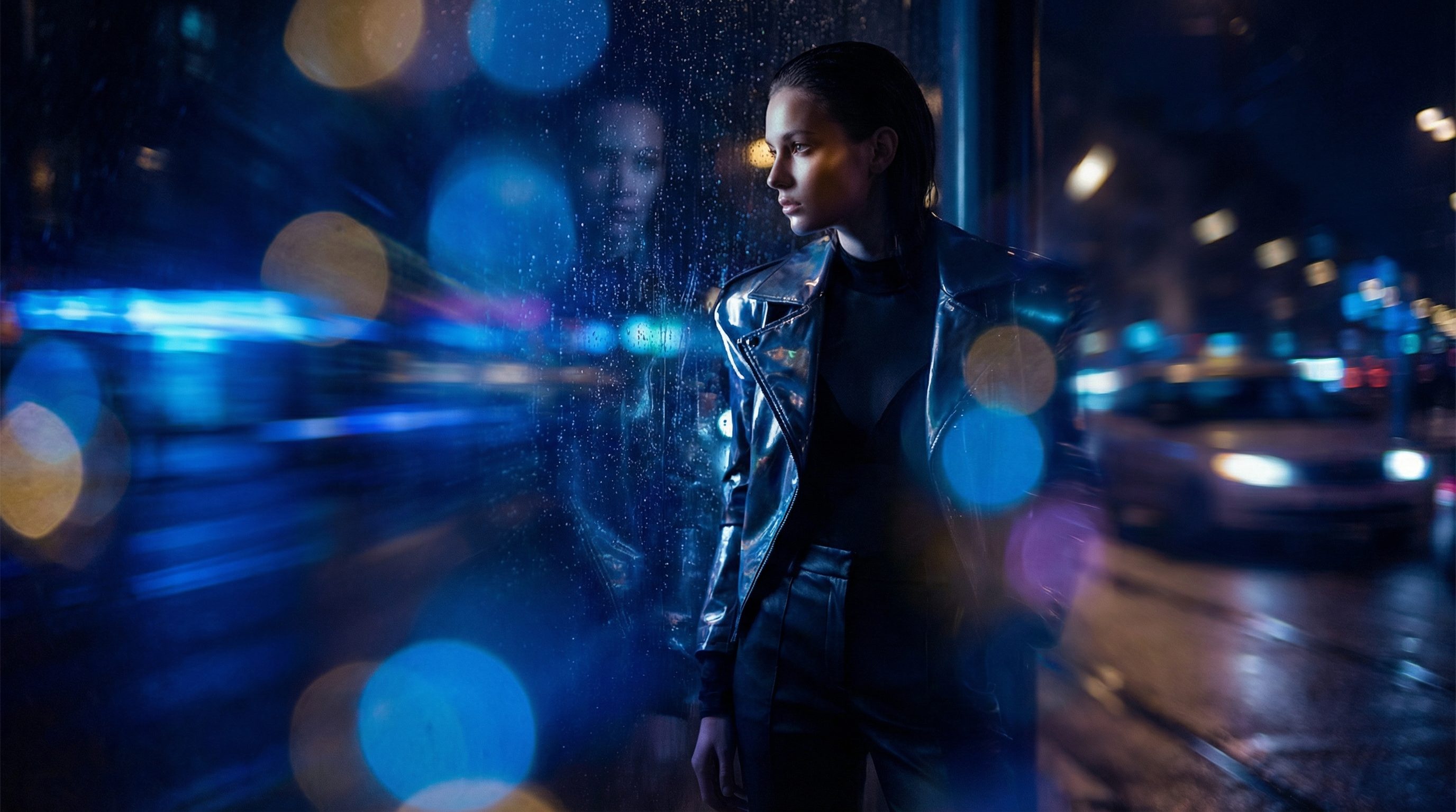 Woman in leather jacket at rainy neon city night